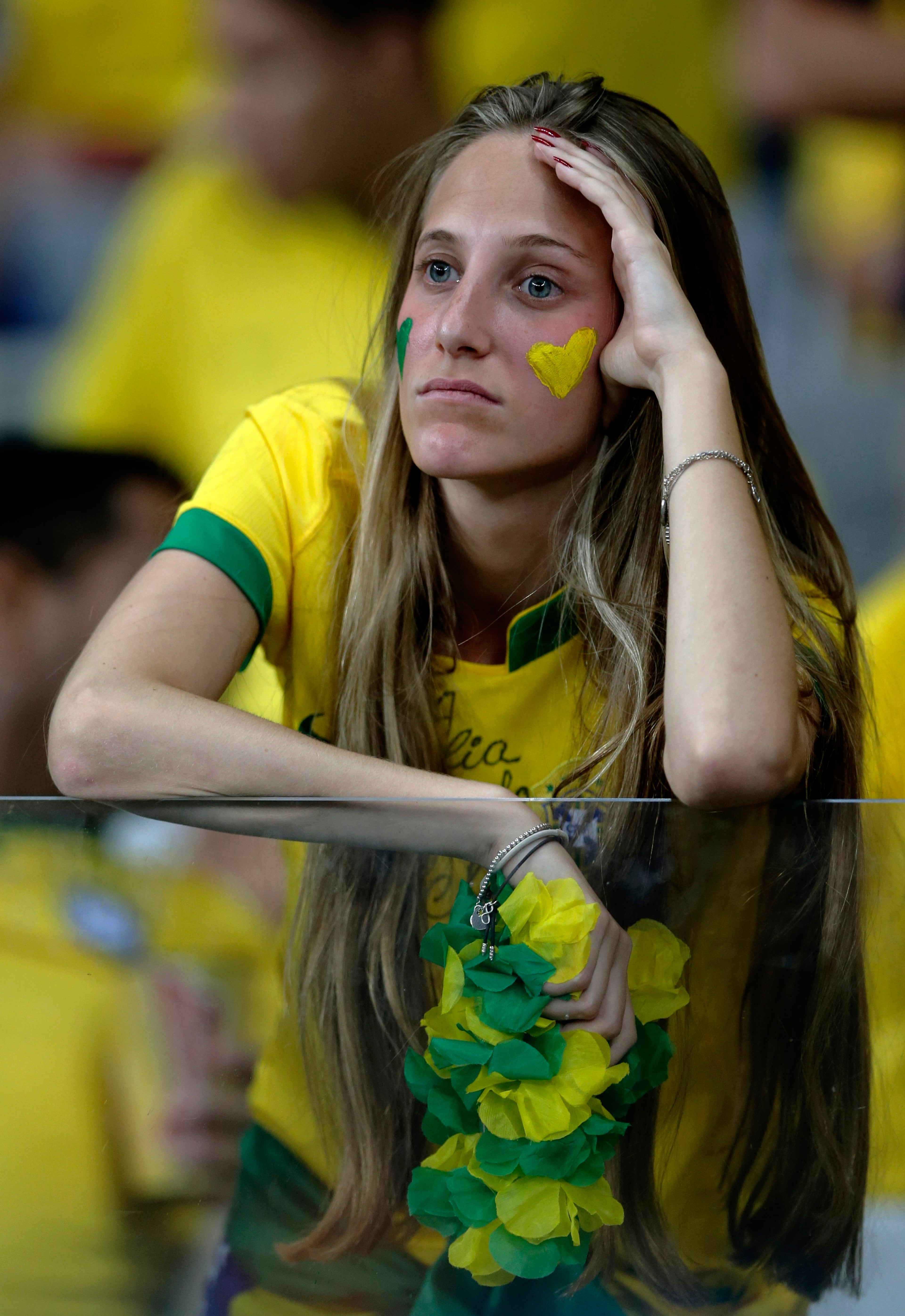 A Brazil supporter reacts during the World Cup semifinal soccer match between Brazil and Germany at the Mineirao Stadium in Belo Horizonte, Brazil, Tuesday, July 8, 2014. (AP Photo/Matthias Schrader)