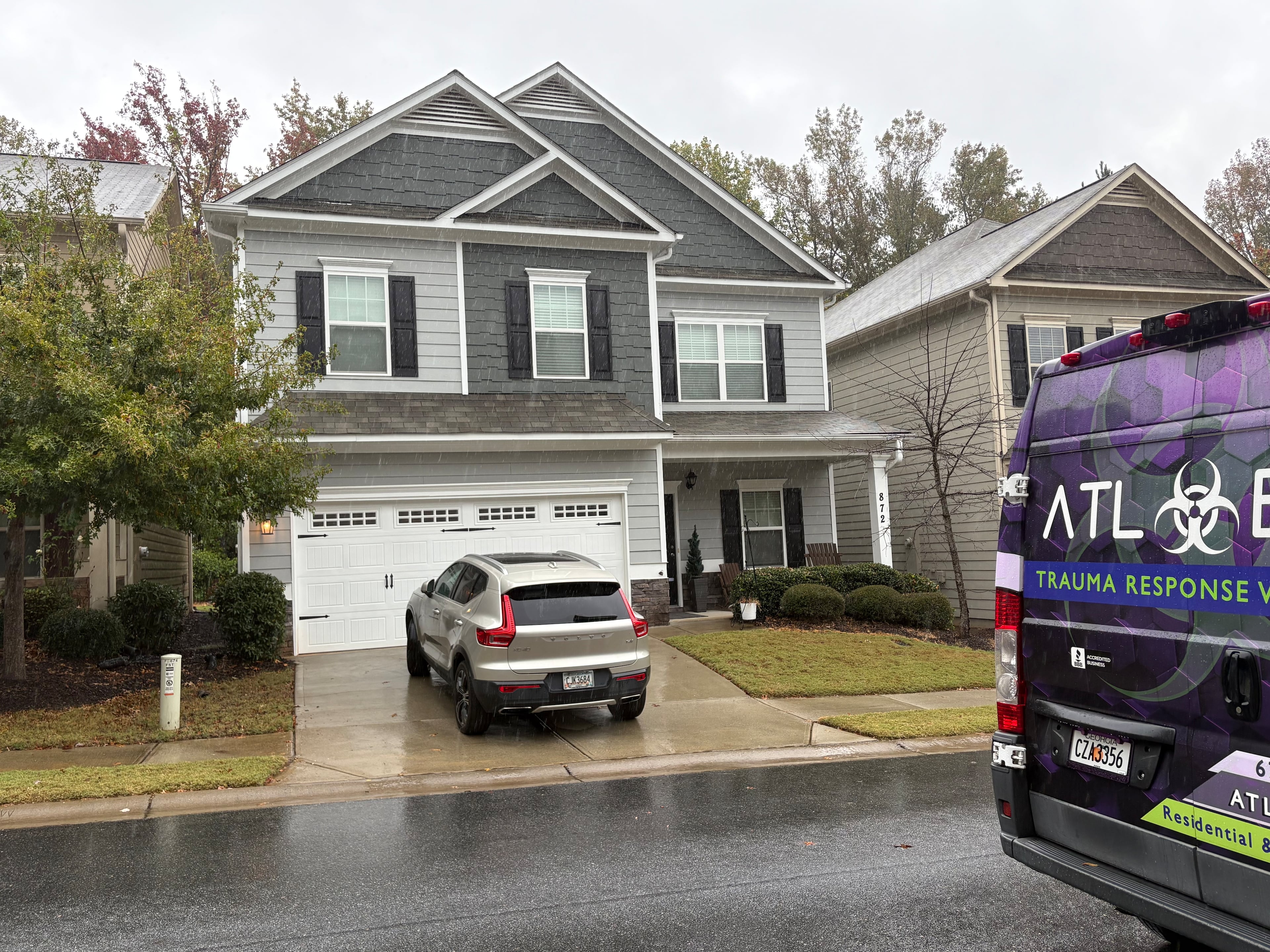 A trauma response vehicle sits Wednesday outside a home on Whisperwood Trail, where Cherokee County deputies fatally shot a man whose mother was found dead inside, authorities said. Oct. 29, 2025.