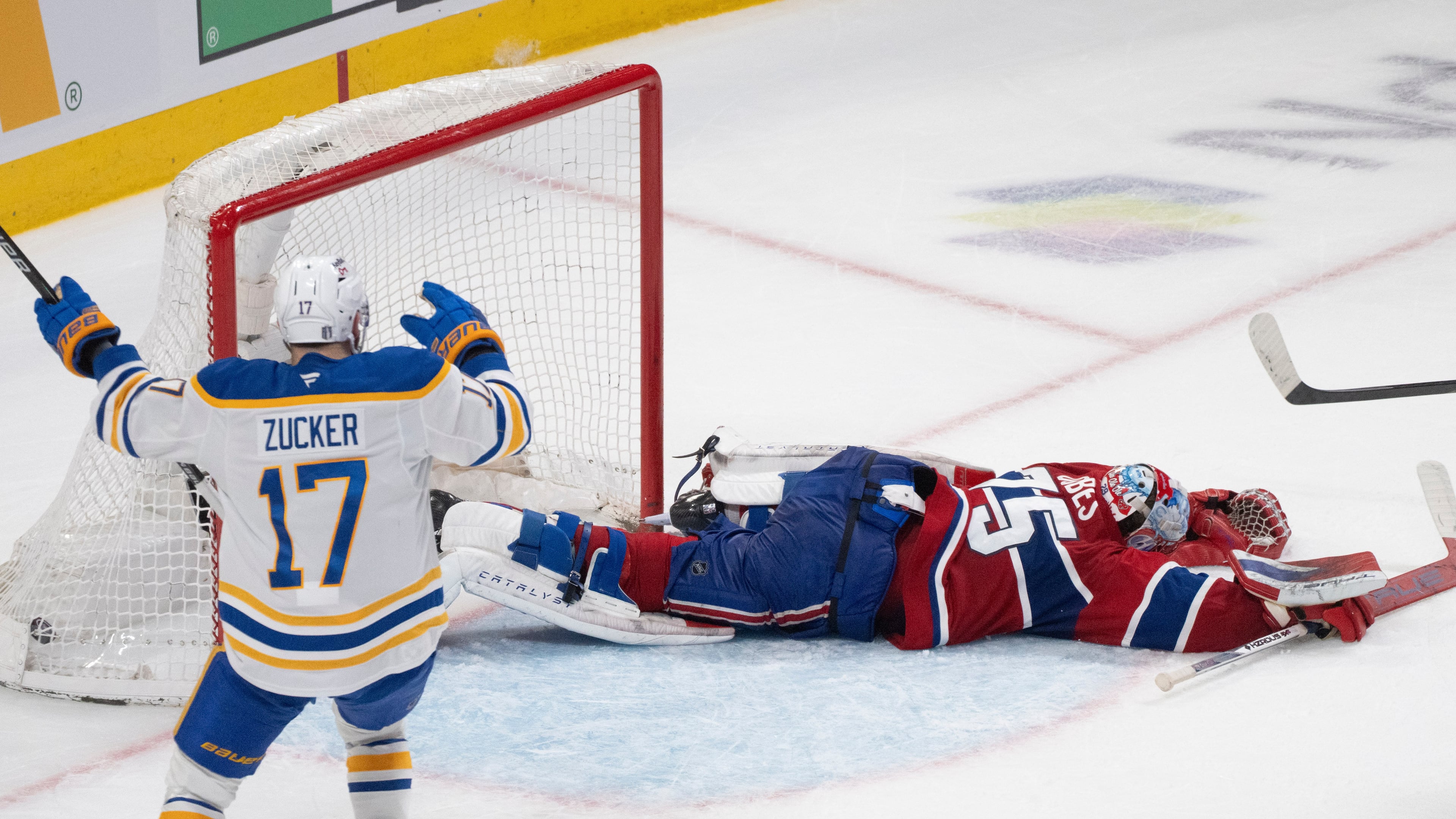 Buffalo Sabres' Jason Zucker (17) celebrates a goal by teammate Konsta Helenius in front of Montreal Canadiens goaltender Jakub Dobes (75) during the second period in Game 6 in a second-round NHL hockey Stanley Cup playoff series in Montreal, Saturday, May 16, 2026. (Christinne Muschi/The Canadian Press via AP)