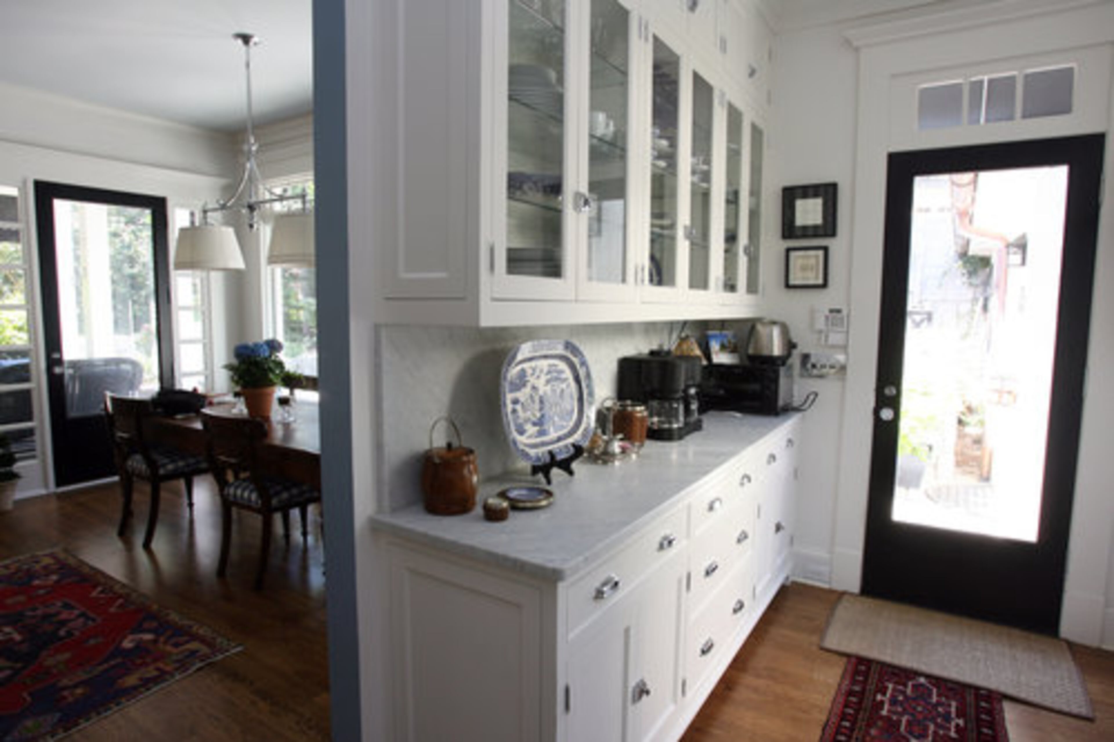 The white cabinets off of the kitchen offer a lot of storage space.