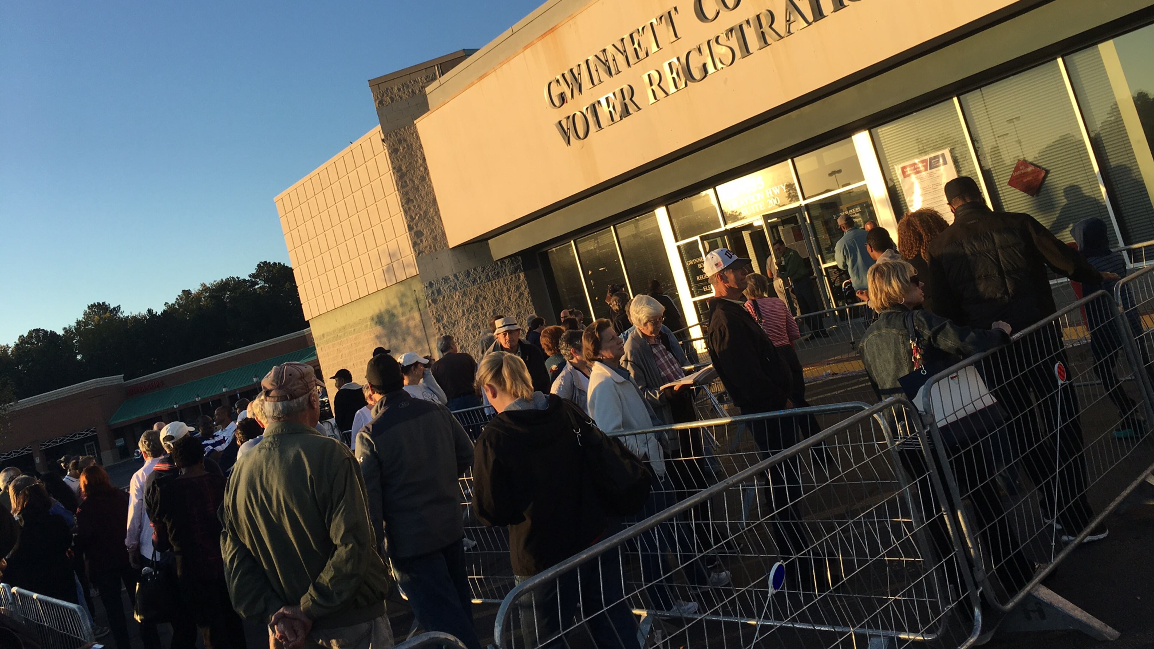 Voters wait outside the Gwinnett County elections office during early voting ahead of the 2016 presidential election. TYLER ESTEP / TYLER.ESTEP@AJC.COM