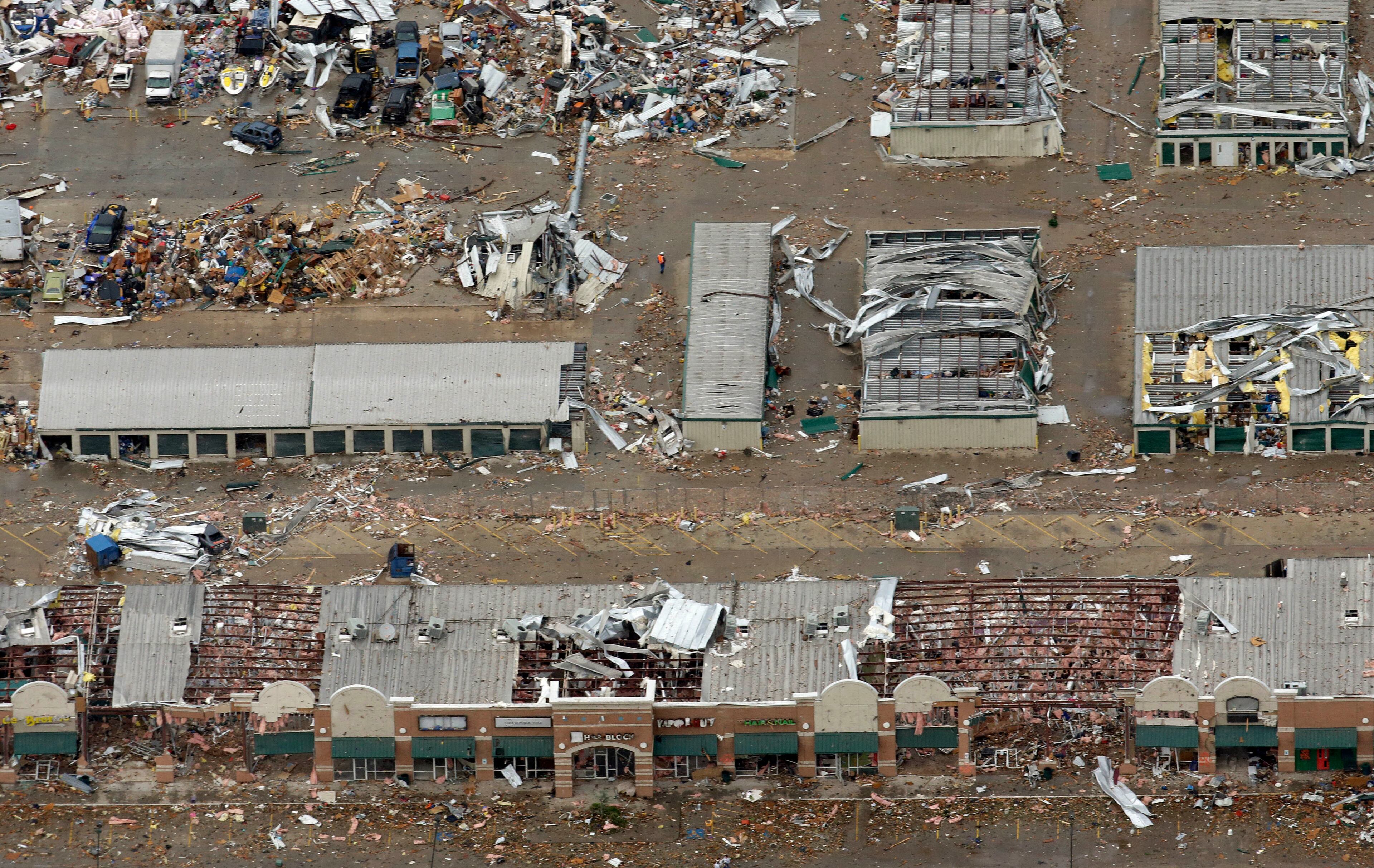 An aerial view shows business structures damaged by Monday's tornado, Tuesday, May 21, 2013, in Moore, Okla. (AP Photo/Tony Gutierrez)