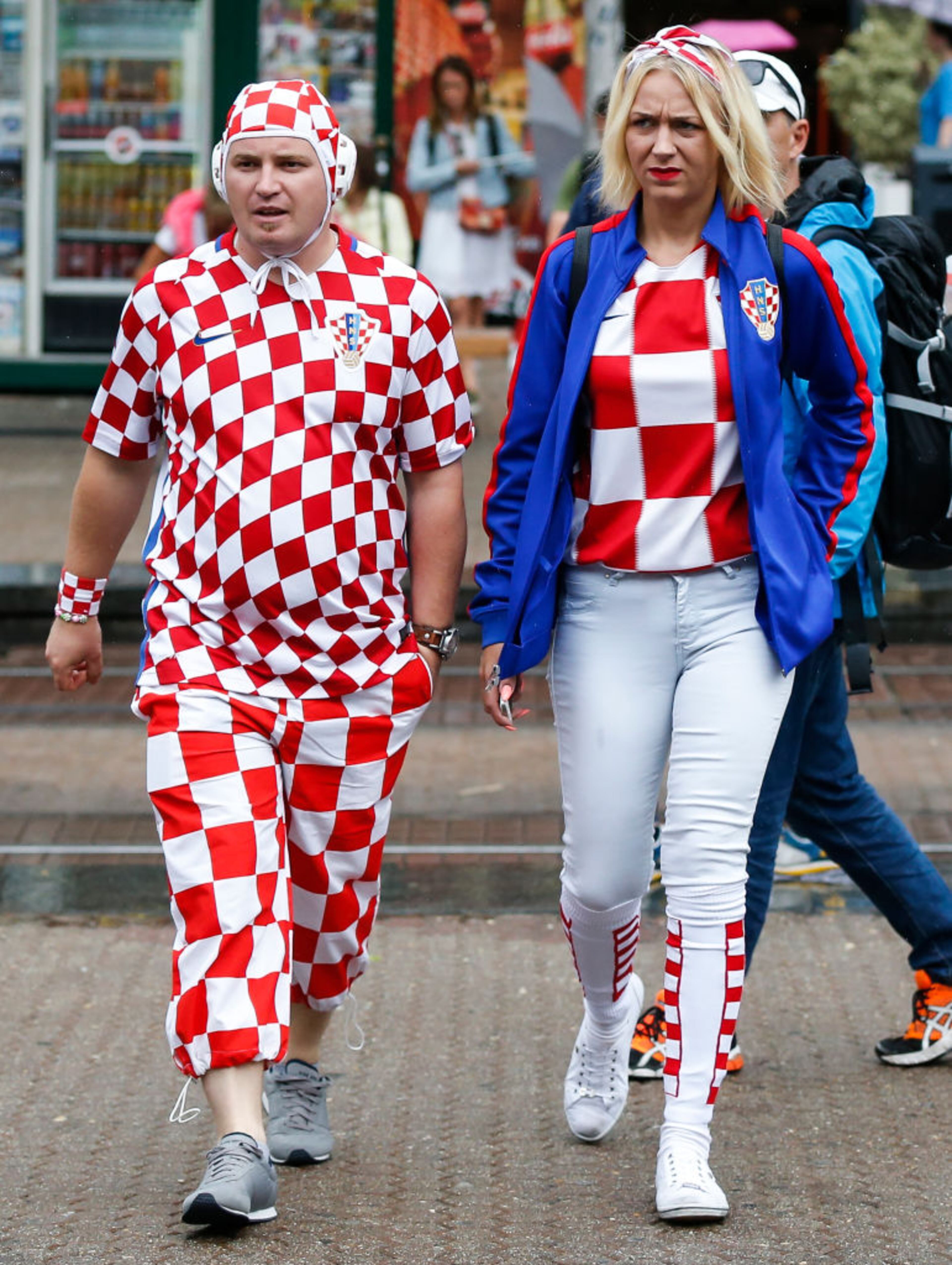 ZAGREB, CROATIA - JULY 15: A couple dressed in the colors of the Croatian coat of arms pass by a square on July 15, 2018 in Zagreb. This is the first time Croatia has reached the final of the Football World Cup. They take on France who are looking for their second World Cup trophy after winning it in 1998. (Photo by Srdjan Stevanovic/Getty Images)
