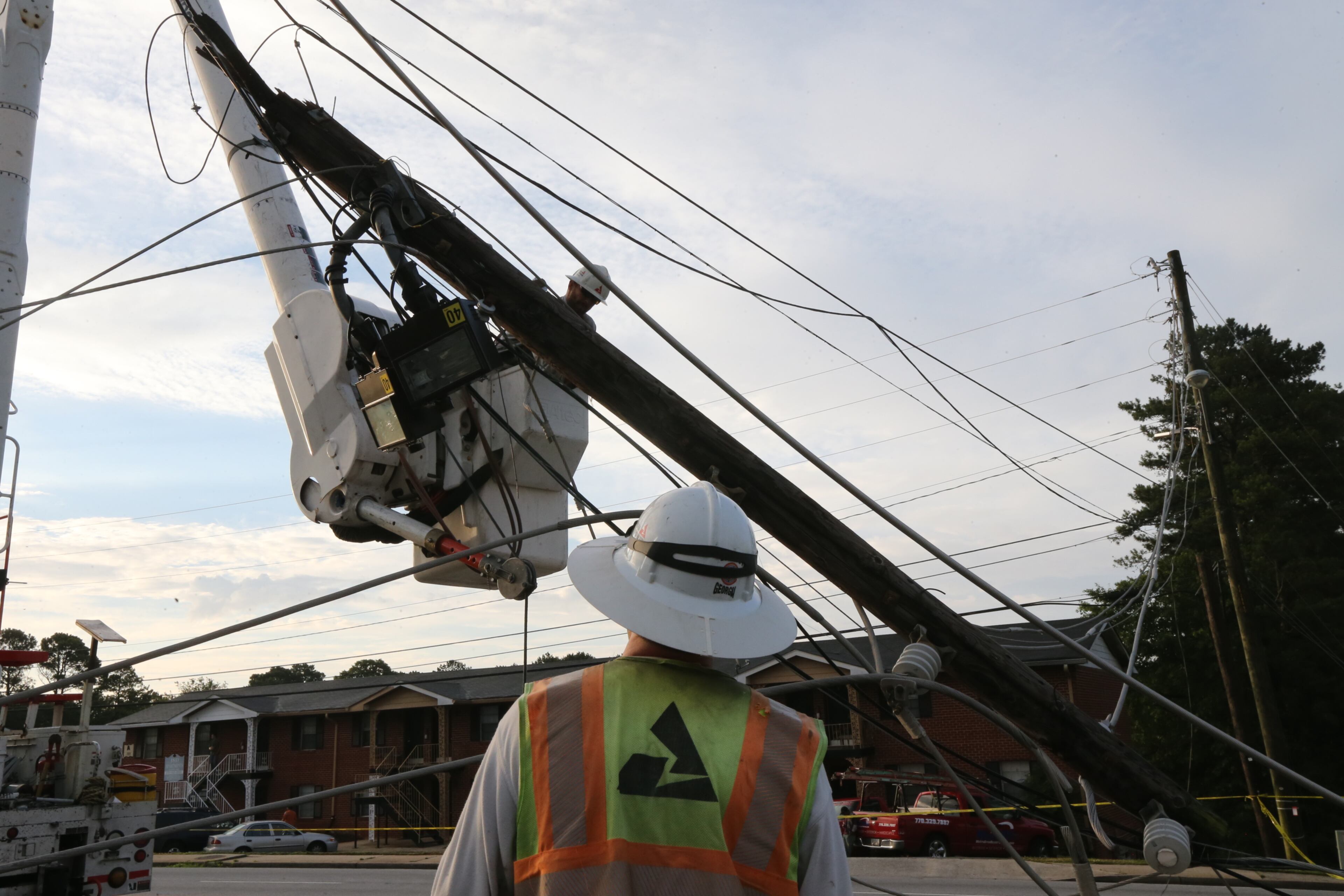 A second pole also fell onto a nearby grassy area. It was not immediately clear what caused the poles to topple. JOHN SPINK/JSPINK@AJC.COM