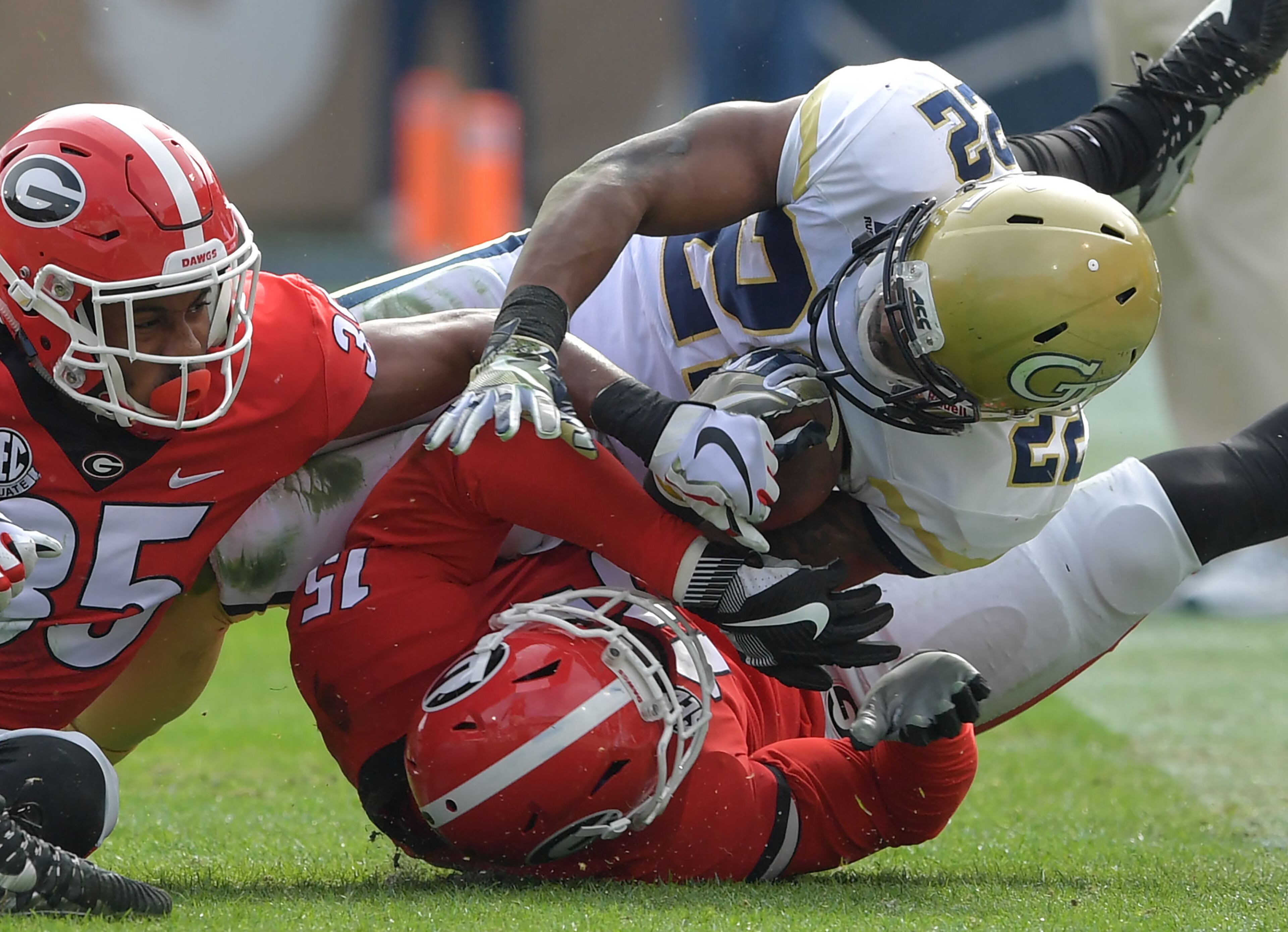 November 25, 2017 Atlanta - Georgia Tech running back Clinton Lynch (22) gets tackled by Georgia linebacker D'Andre Walker (15) in the first half of an NCAA college football game at Bobby Dodd Stadium on Saturday, November 25, 2017. HYOSUB SHIN / HSHIN@AJC.COM