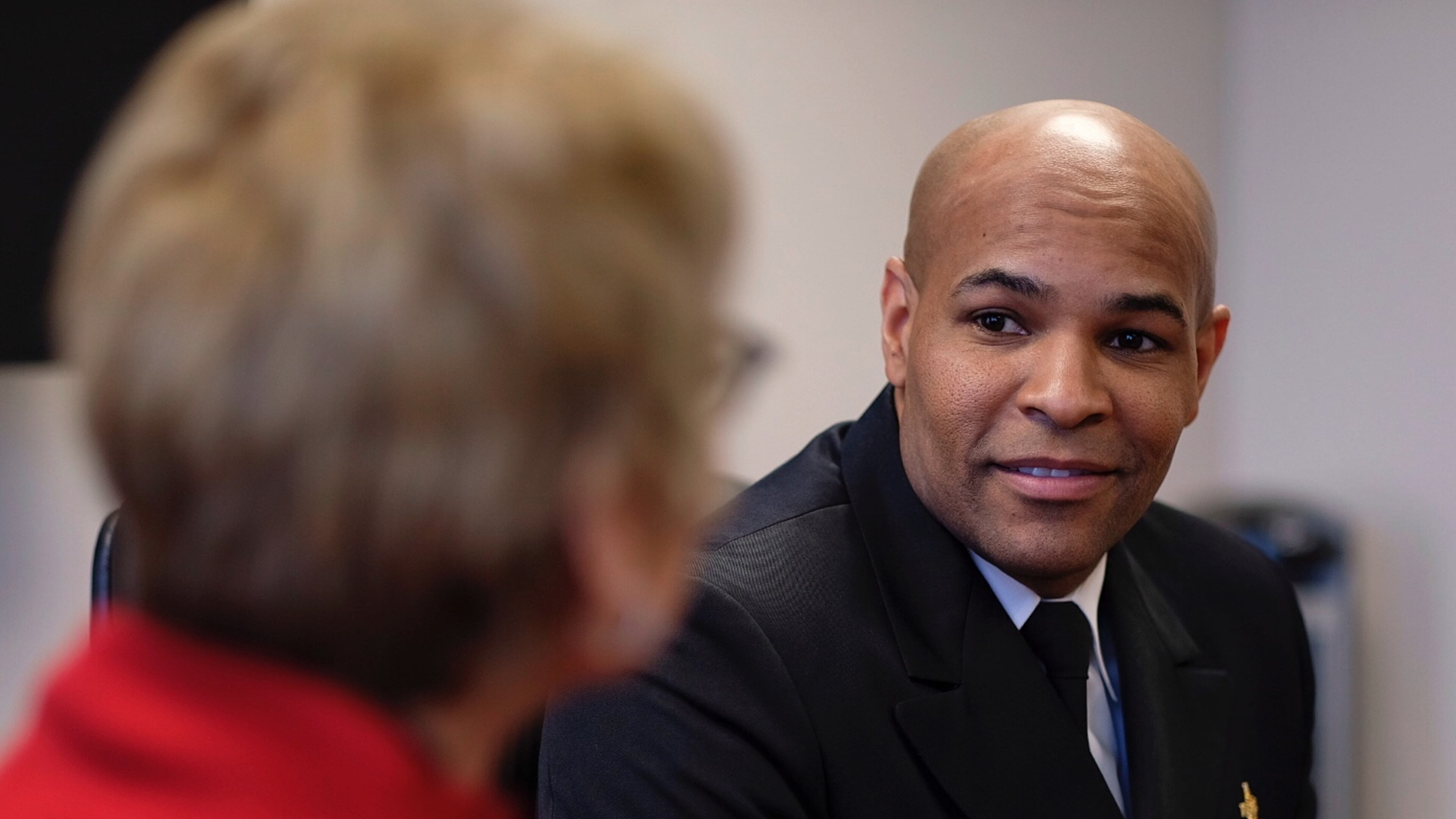 Surgeon General Jerome Adams speaks with State Public Health Commissioner Dr. Kathleen Toomey on Friday, March, 2020 in Atlanta.