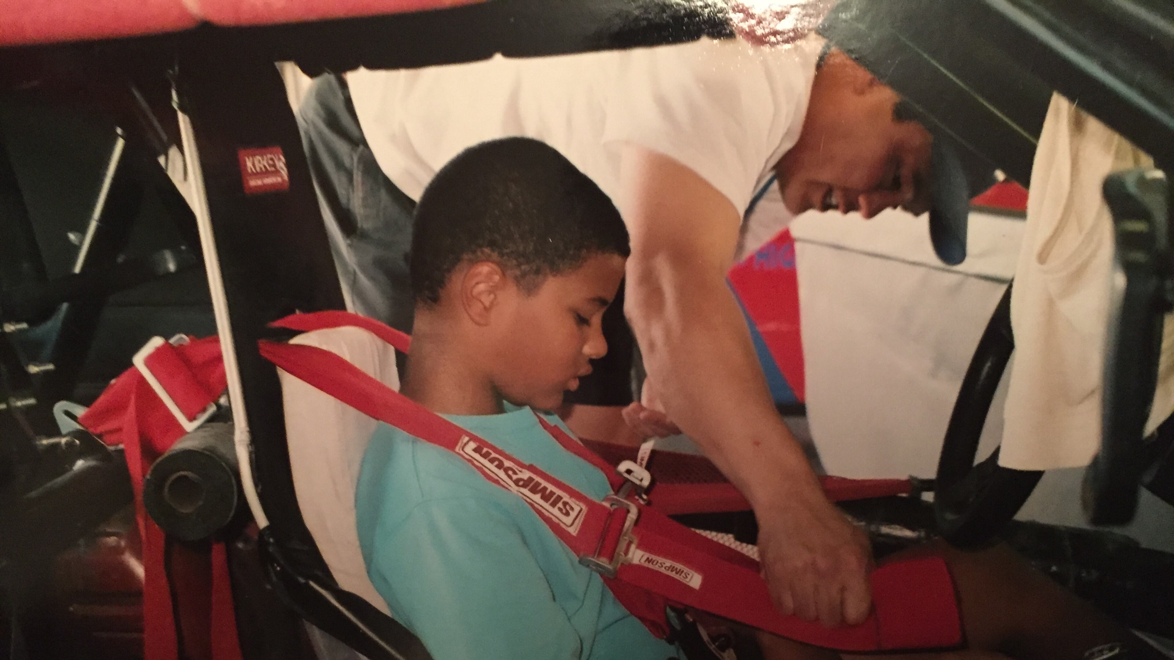 A young Eason Fromayan tests out a race-car cockpit. (Courtesy Fromayan family)