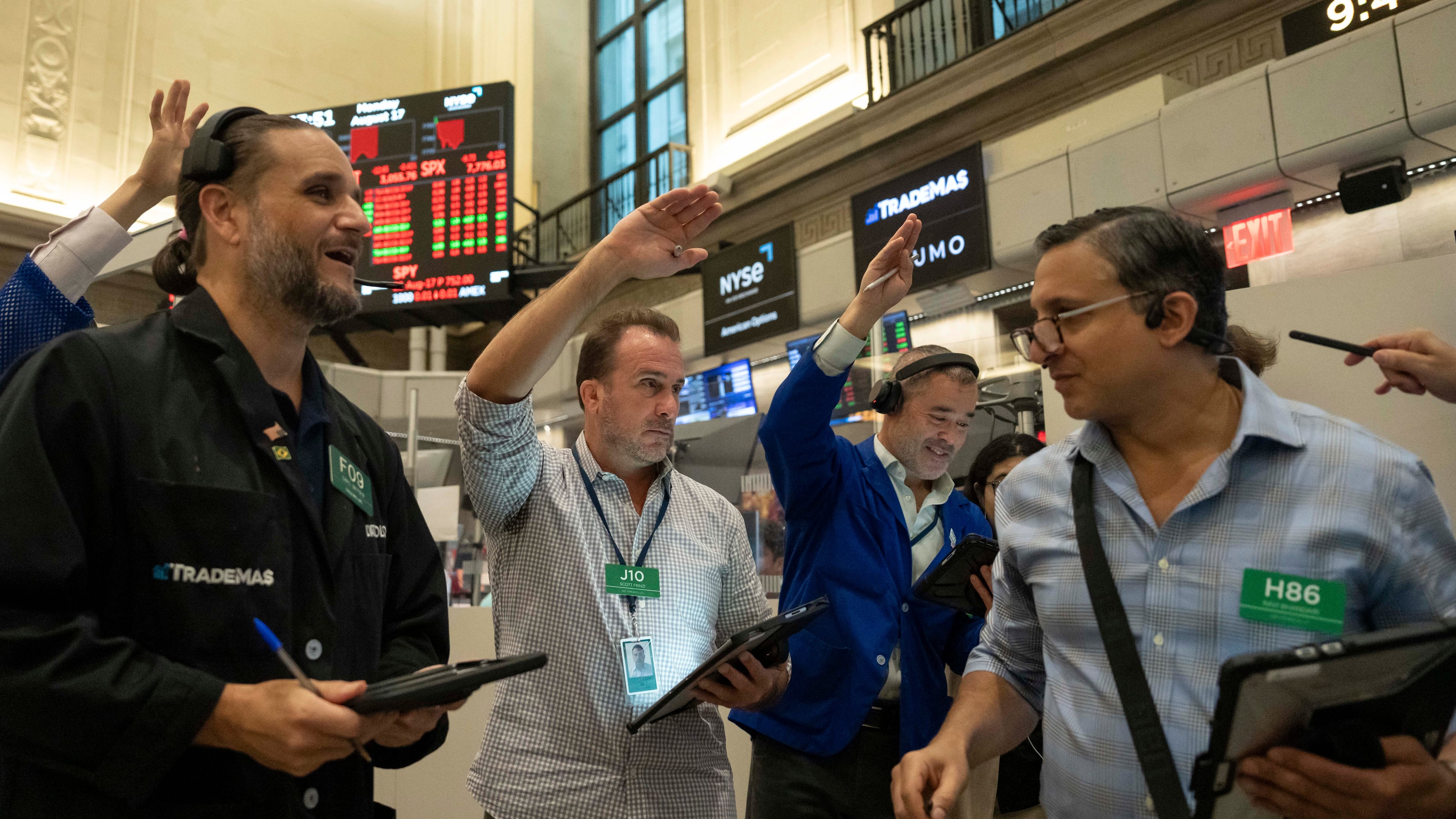 Options traders Chris Dattolo, Scott Frinzi, Justin Kanda, and Ravi Bhandari, left to right, work on the floor of the New York Stock Exchange, Monday, Aug. 17, 2026, in New York. (AP Photo/Yuki Iwamura)