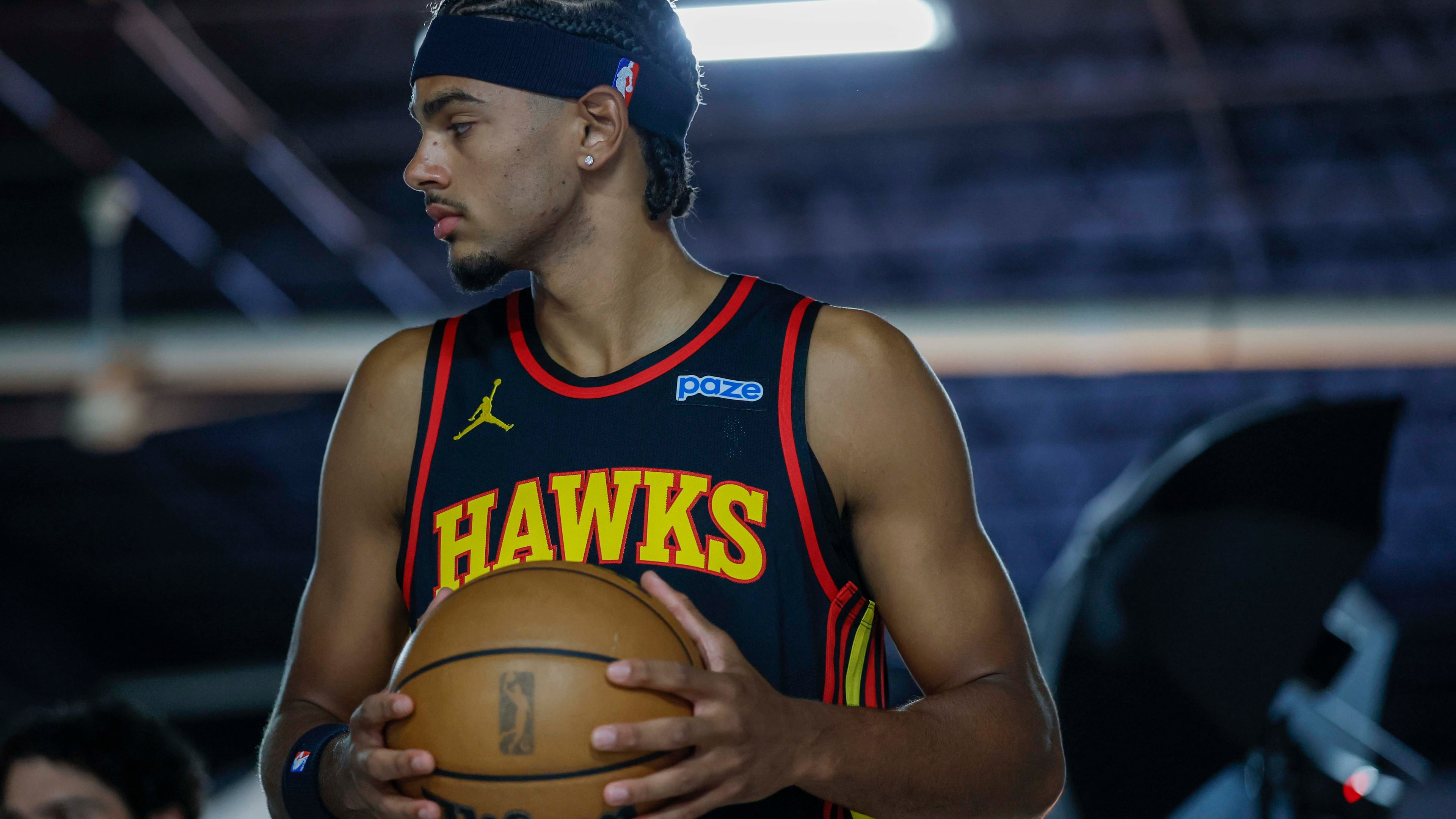 Atlanta Hawks forward Asa Newell holds the ball as he poses for Getty Images photographer Todd Kirkland during the NBA team’s media day at PC&E Atlanta on Monday, Sept. 28, 2026, in Atlanta. (Miguel Martinez/AJC)