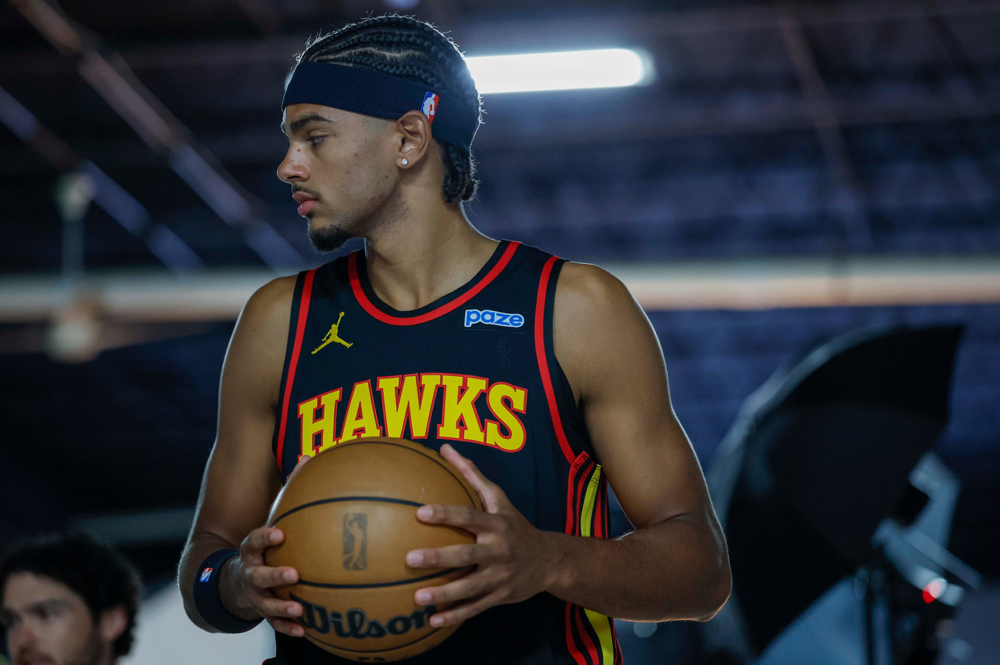Atlanta Hawks forward Asa Newell holds the ball as he poses for Getty Images photographer Todd Kirkland during the NBA team’s media day at PC&E Atlanta on Monday, Sept. 28, 2026, in Atlanta. (Miguel Martinez/AJC)