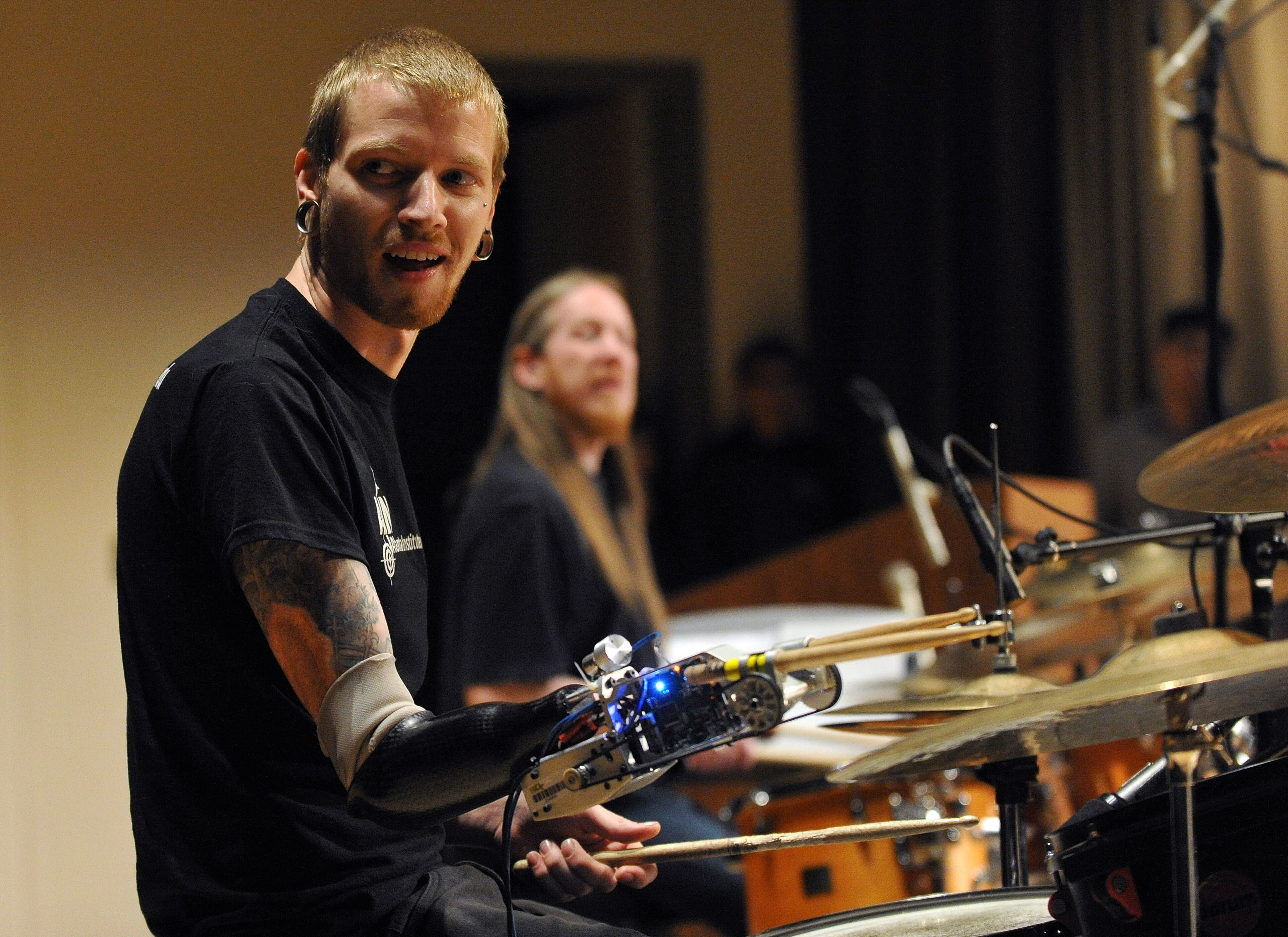 Musician Jason Barnes, left, uses his myo-electrically controlled robot arm during practice with his Atlanta Institute of Music teacher Eric Sanders before they performed a drum duet at Kennesaw State University on Saturday March 21, 2014 in Kennesaw, Ga. David Tulis / AJC Special