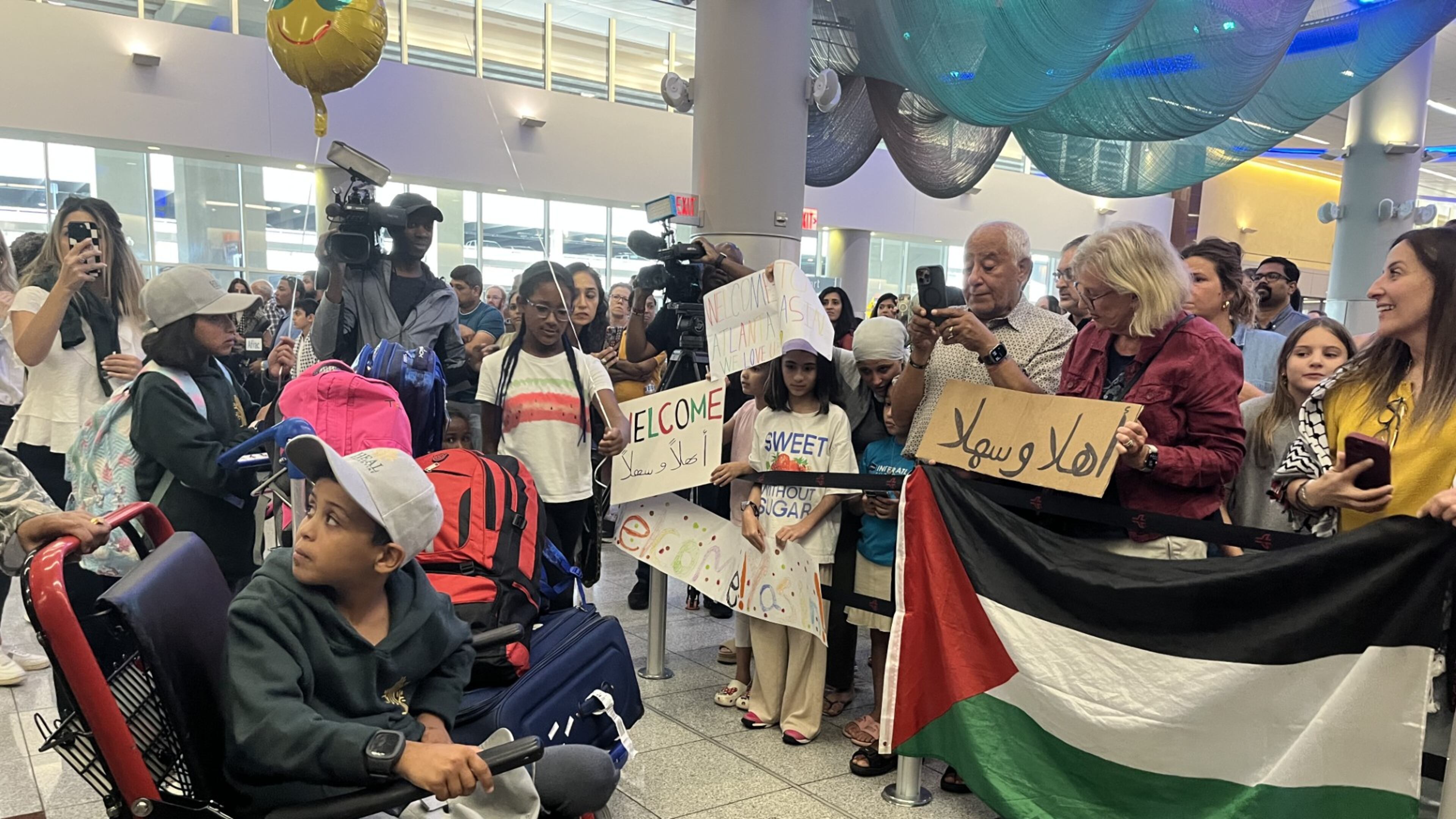Supporters greet 12-year-old Yassin Alghalban at Hartsfield-Jackson Atlanta International Airport on Sunday as he arrives from Gaza. (Safa Wahidi/AJC).