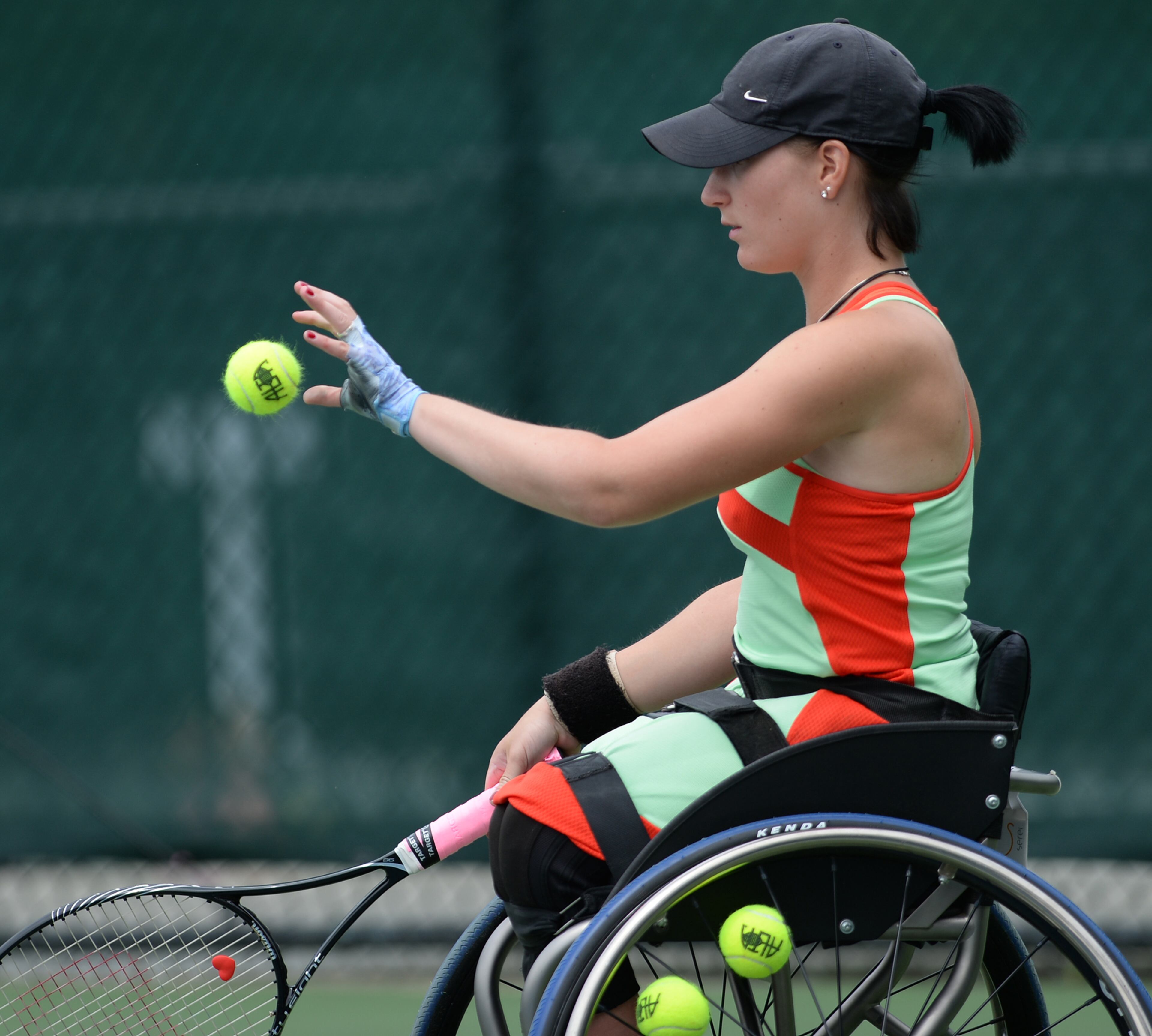 Katharina Kruger, Germany, grabs a tennis ball during the Atlanta Open Wheelchair Tennis Championships at the Dunwoody Country Club on Wednesday, May 1, 2013. T JOHNNY CRAWFORD / JCRAWFORD@AJC.COM