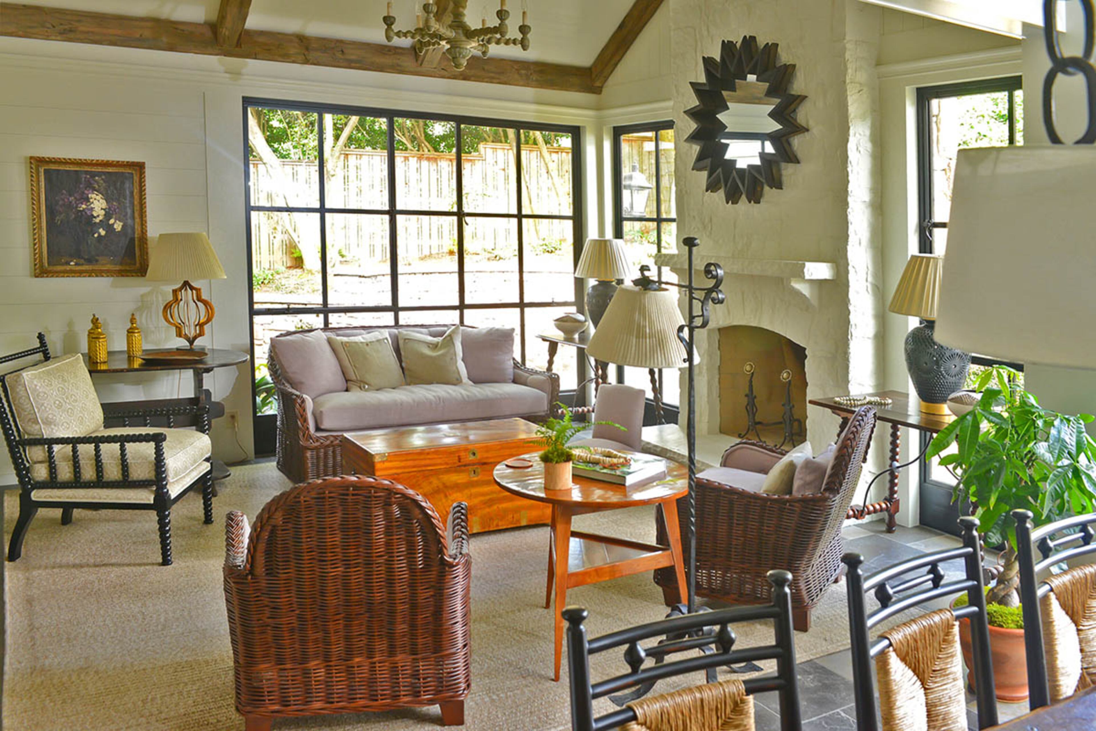 A trunk functions not only as a coffee table but, together with another trunk found in the family room, as a link to Johnson's family history. Through coincidence and luck, one trunk has her grandmother's and great-grandmother's initials on it, while the other has her their names on it, though neither are heirlooms. The starburst mirror above the fireplace adds a touch of black to the decor, an element Johnson usually tries to incorporate.