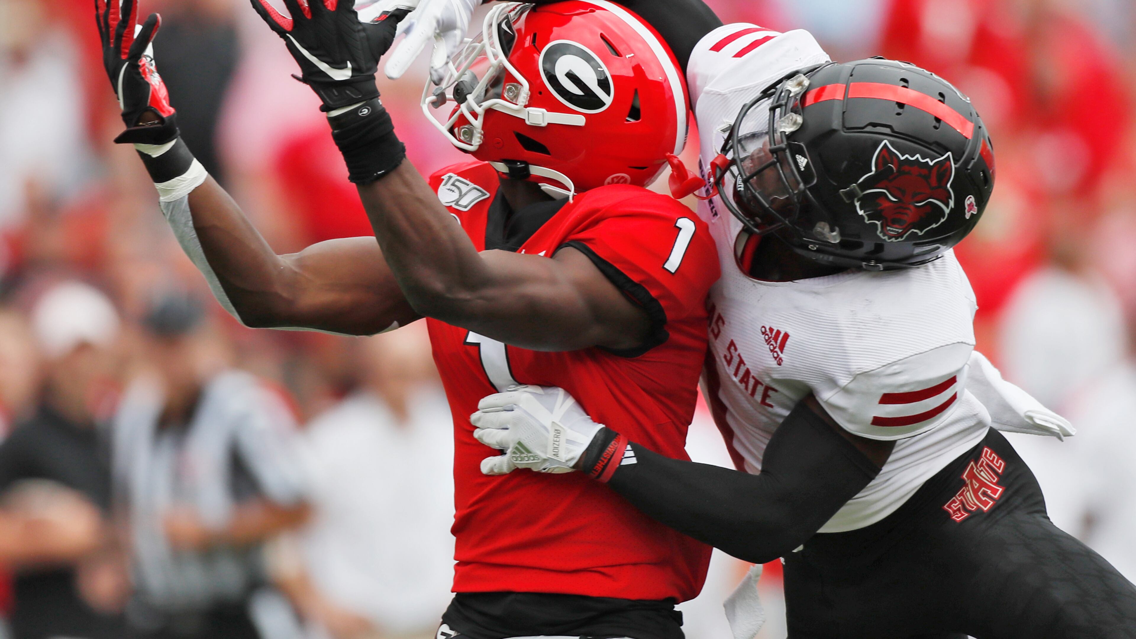 No penalty was called on the defense as Georgia Bulldogs wide receiver George Pickens (1) can't haul in this pass defended by Arkansas State Red Wolves cornerback Jerry Jacobs (1). Bob Andres / robert.andres@ajc.com