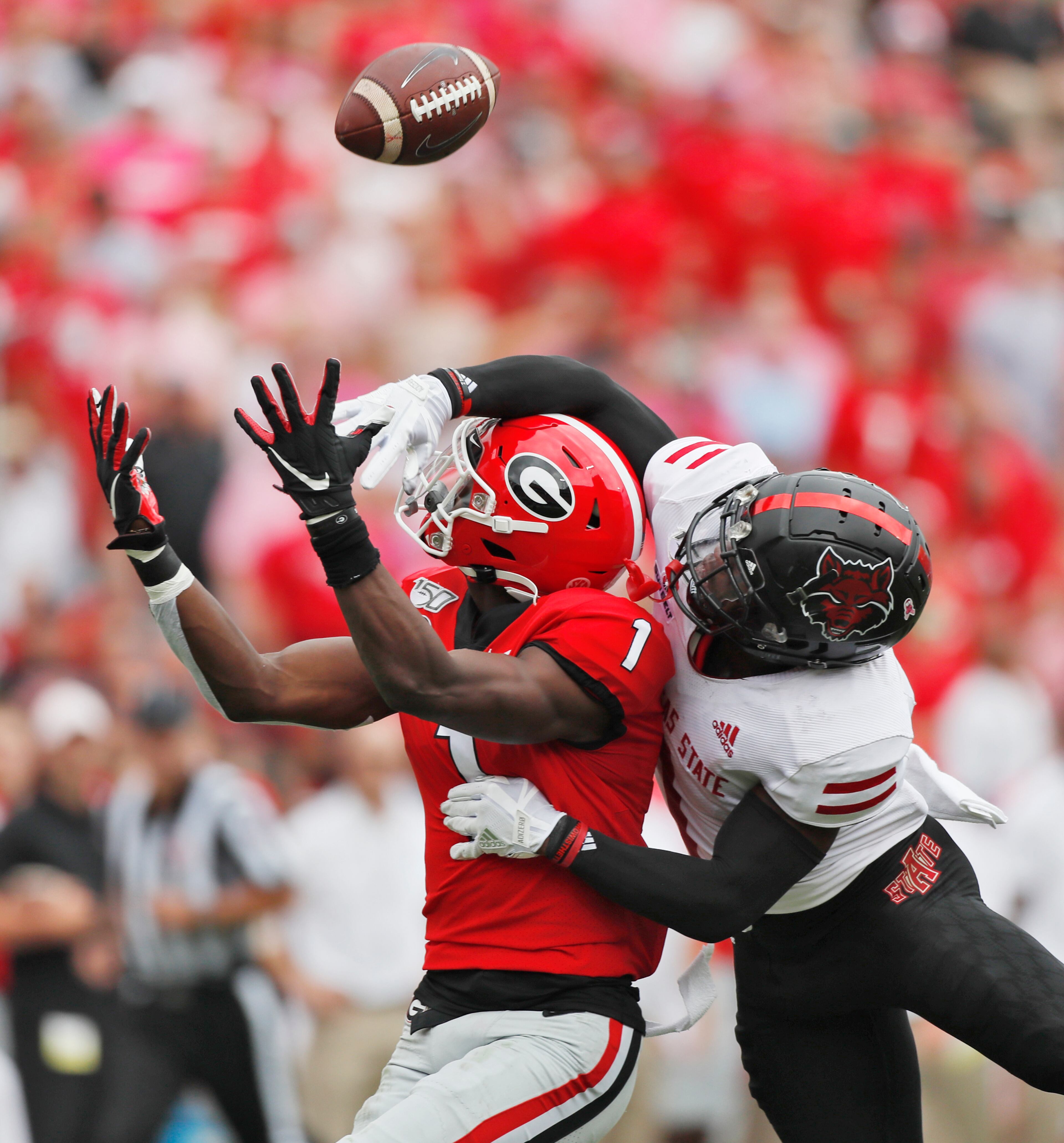 No penalty was called on the defense as Georgia Bulldogs wide receiver George Pickens (1) can't haul in this pass defended by Arkansas State Red Wolves cornerback Jerry Jacobs (1). Bob Andres / robert.andres@ajc.com
