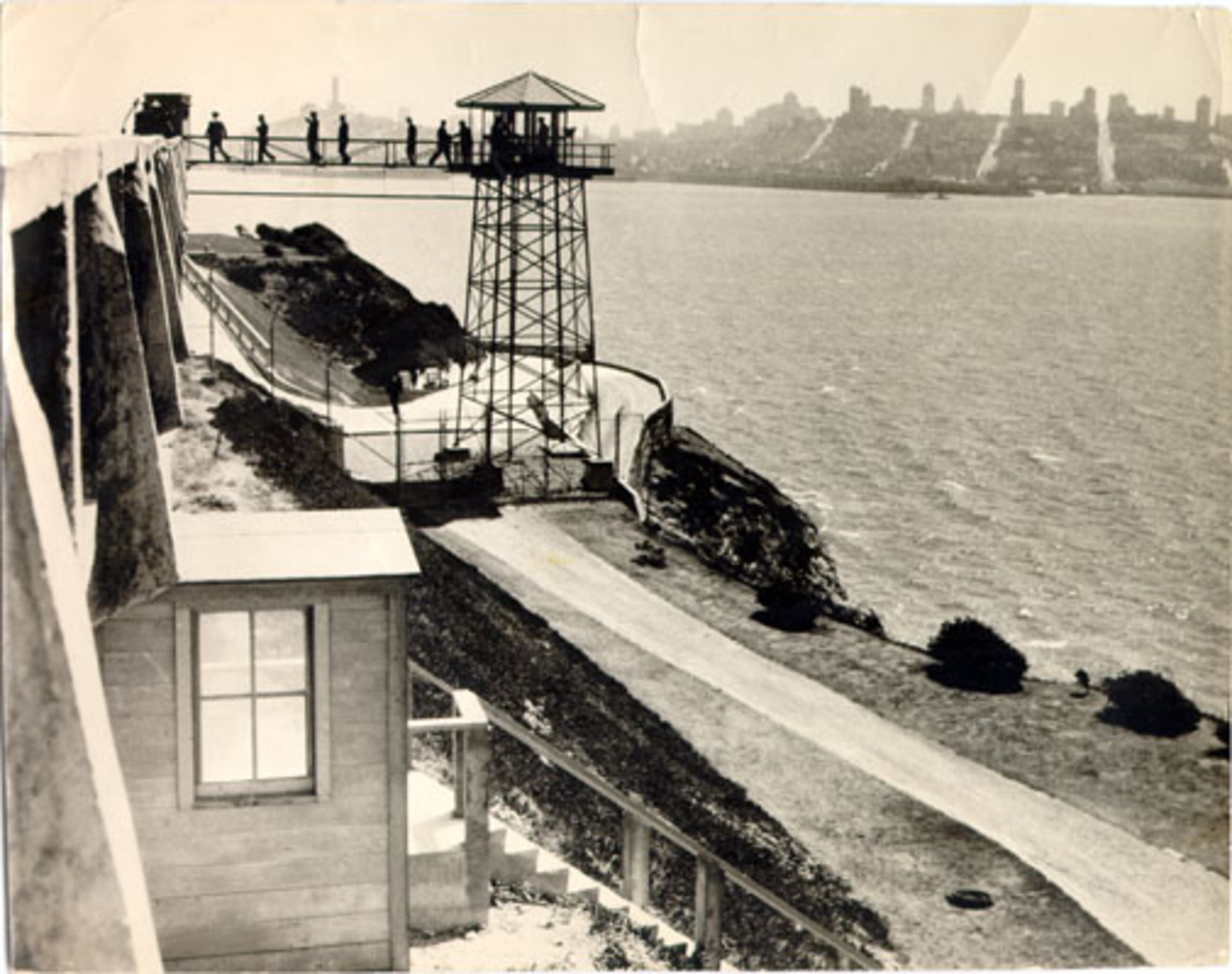 Group of people on walkway to guard tower at Alcatraz Island Federal Penitentiary 1934 August
