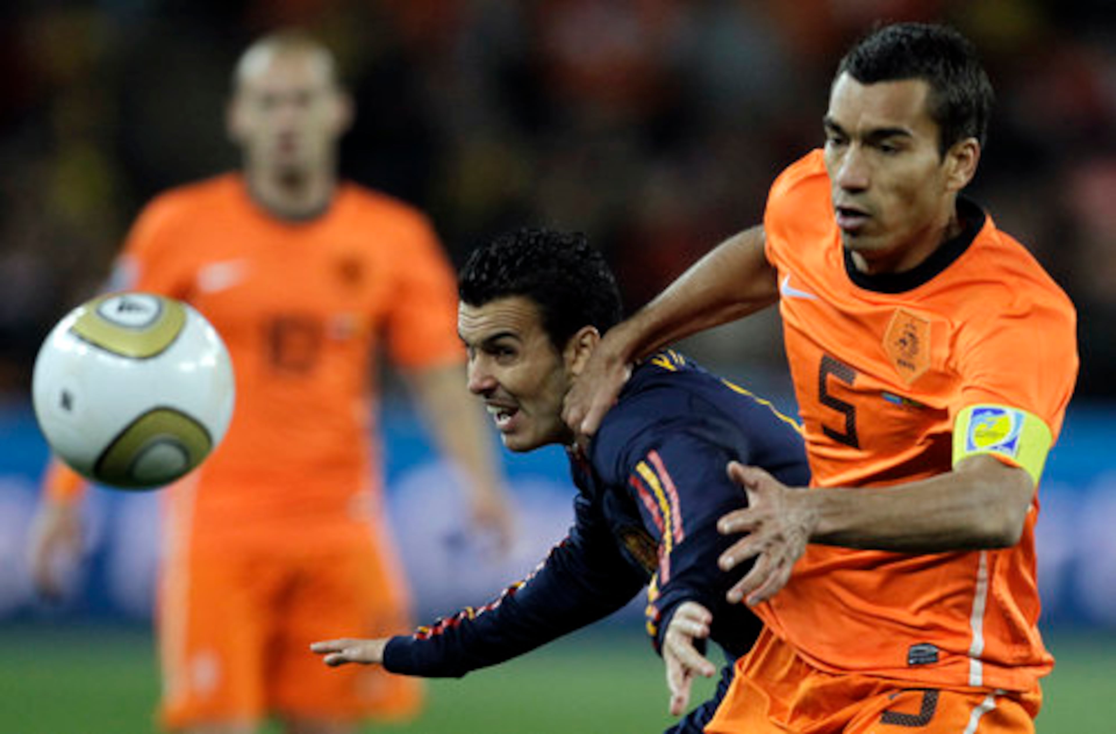 Spain's Pedro Rodriguez, left, vies for the ball with Netherlands' Giovanni van Bronckhorst.