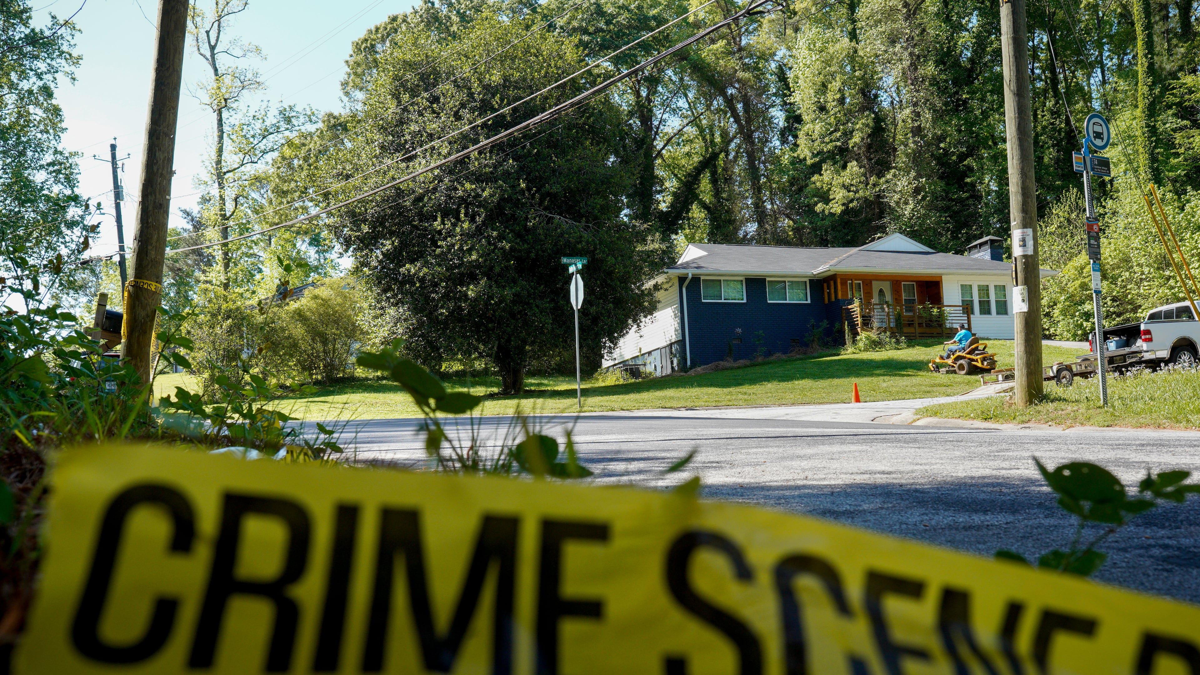 Only police tape remained on the street where Lauren Bullis, a U.S. Department of Homeland Security employee, was killed while walking her dog April 13, 2026. The shooting suspect, Olaolukitan Adon Abel, died in custody Tuesday, the DeKalb County Sheriff's Office says. (Ben Hendren for the AJC)