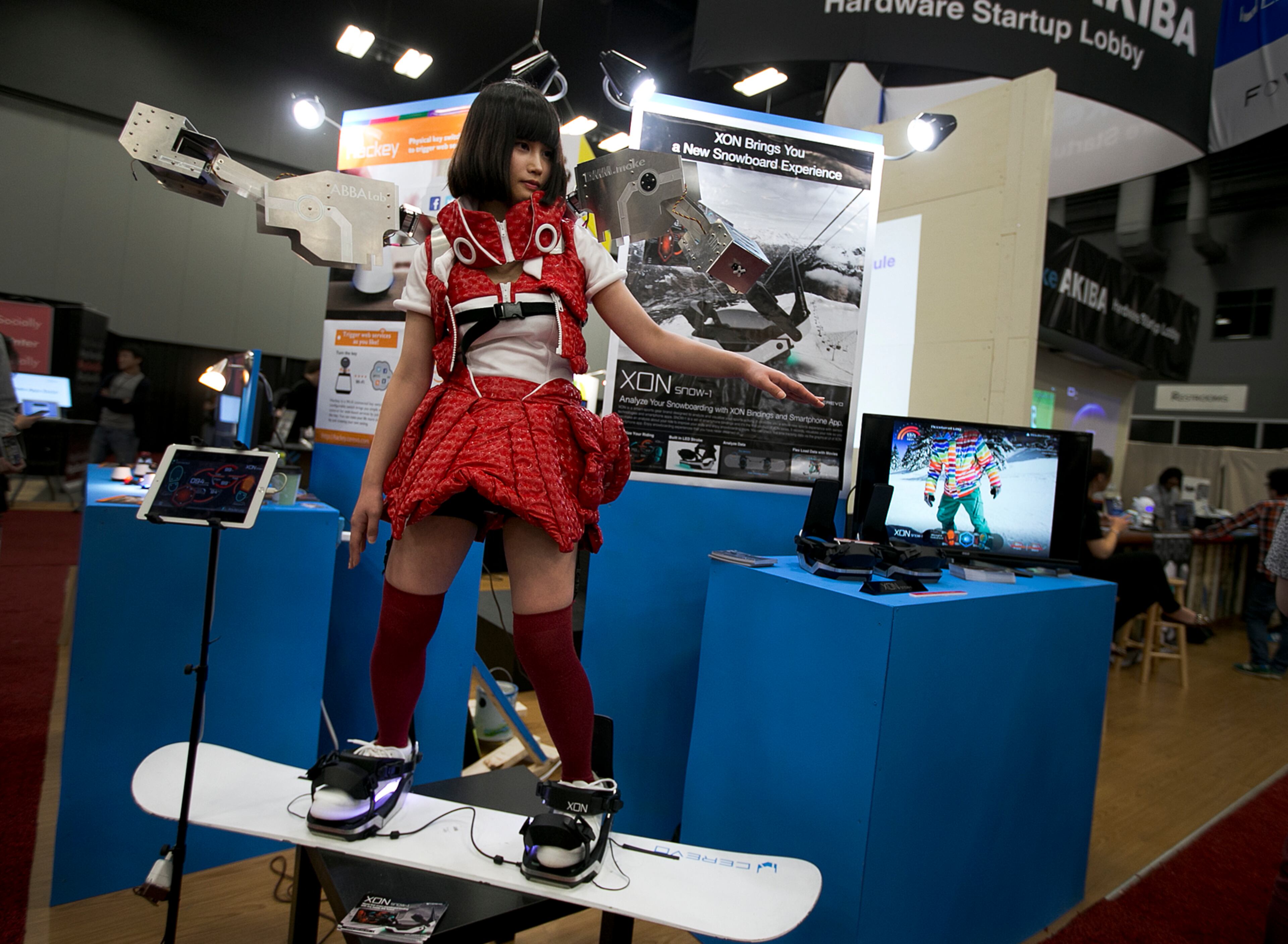 A woman uses a XON snow-1 at the trade show during SXSW at the Austin Convention Center on Monday, March 16, 2015. The device is a binding system with an app that helps you to analyze your performance on the snowboard.