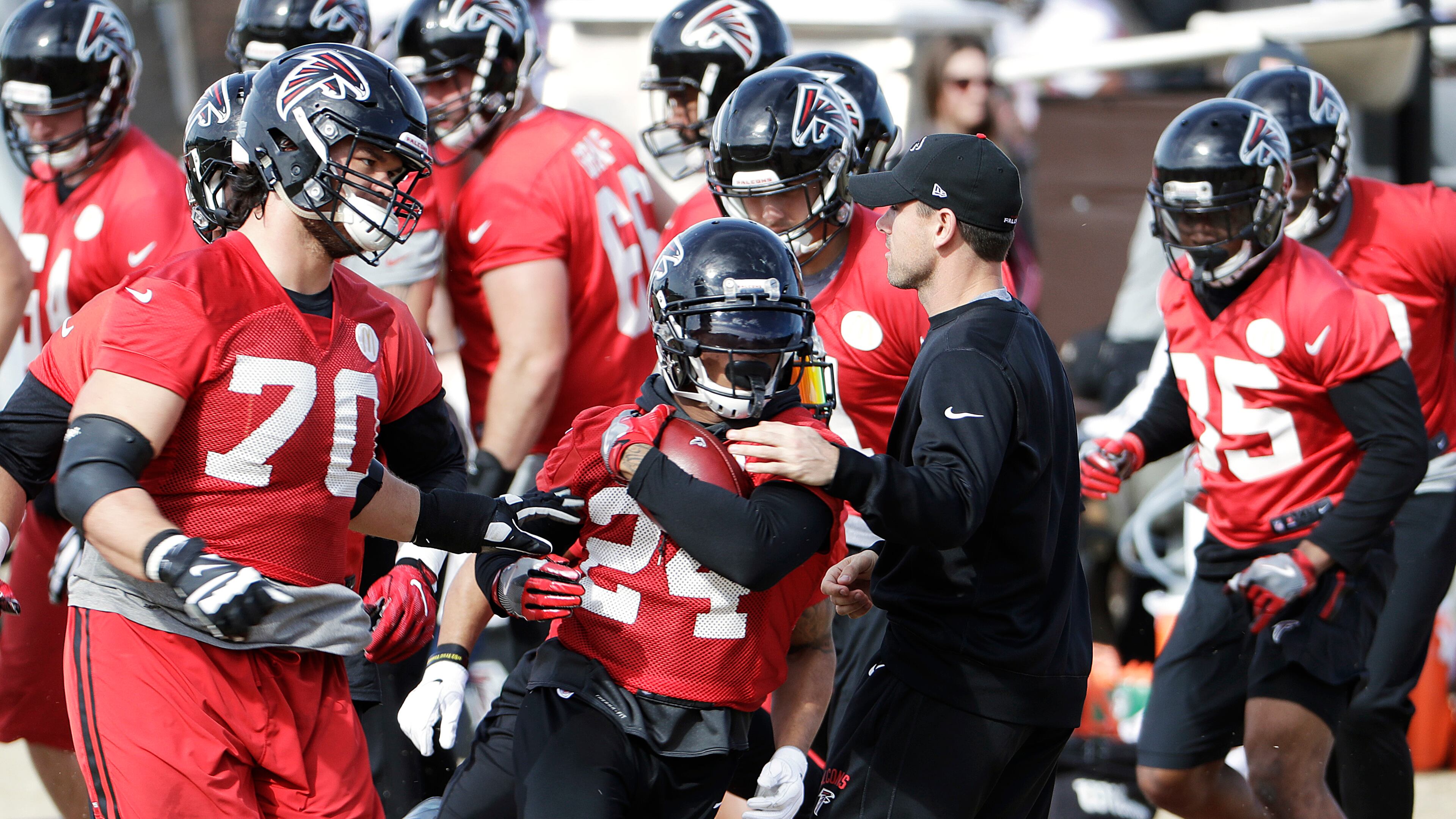 Atlanta Falcons running back Devonta Freeman (24) runs through a drill during a workout at the football team's practice facility in Flowery Branch, Ga., Wednesday, Jan. 25, 2017. (AP Photo/David Goldman)