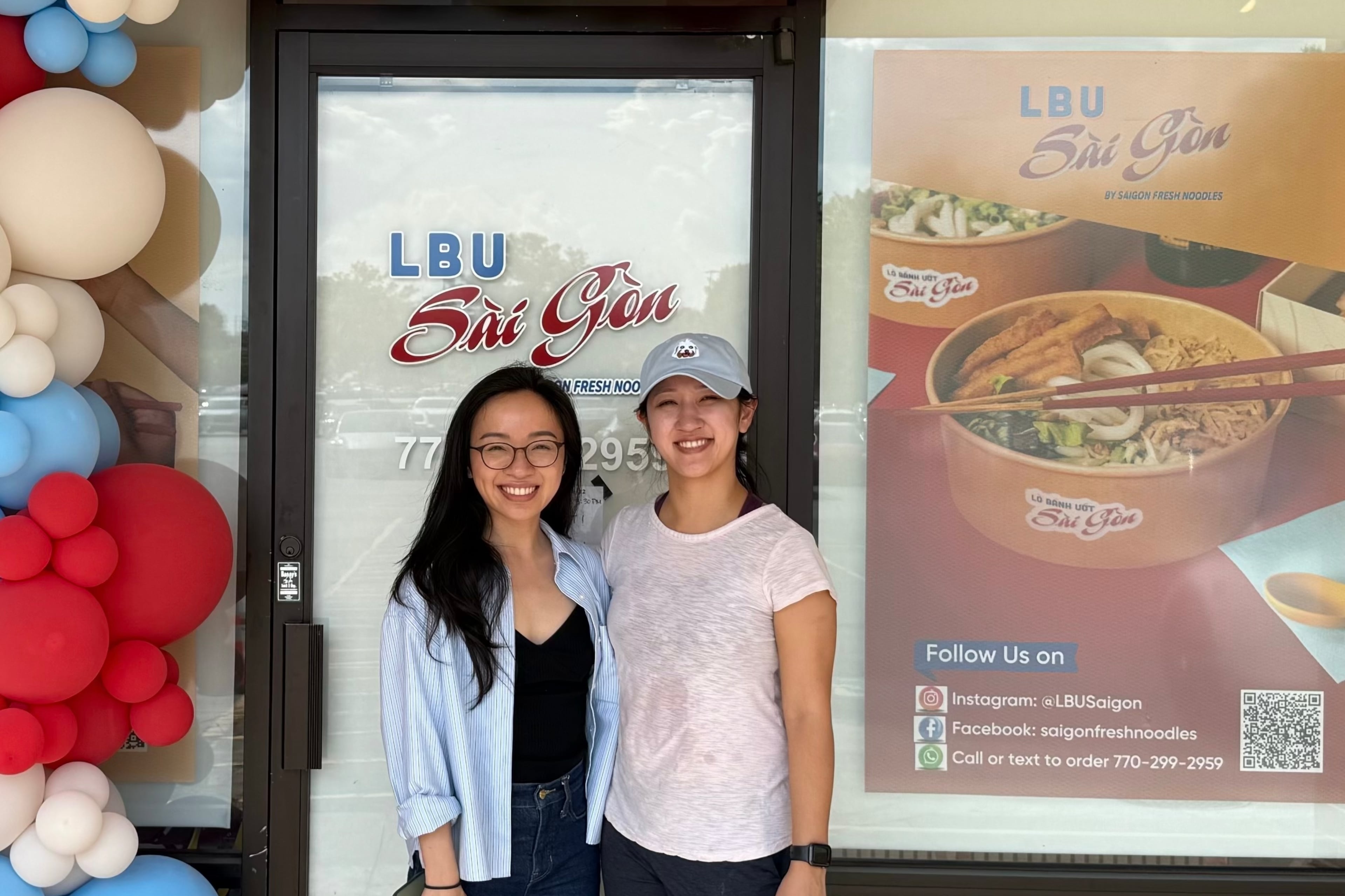 Trang Vu (left) and her sister, Trinh Vu stand in front of LBU Saigon, which makes fresh Vietnamese-style noodles for their own business and other stores. (Courtesy of Trang Vu)