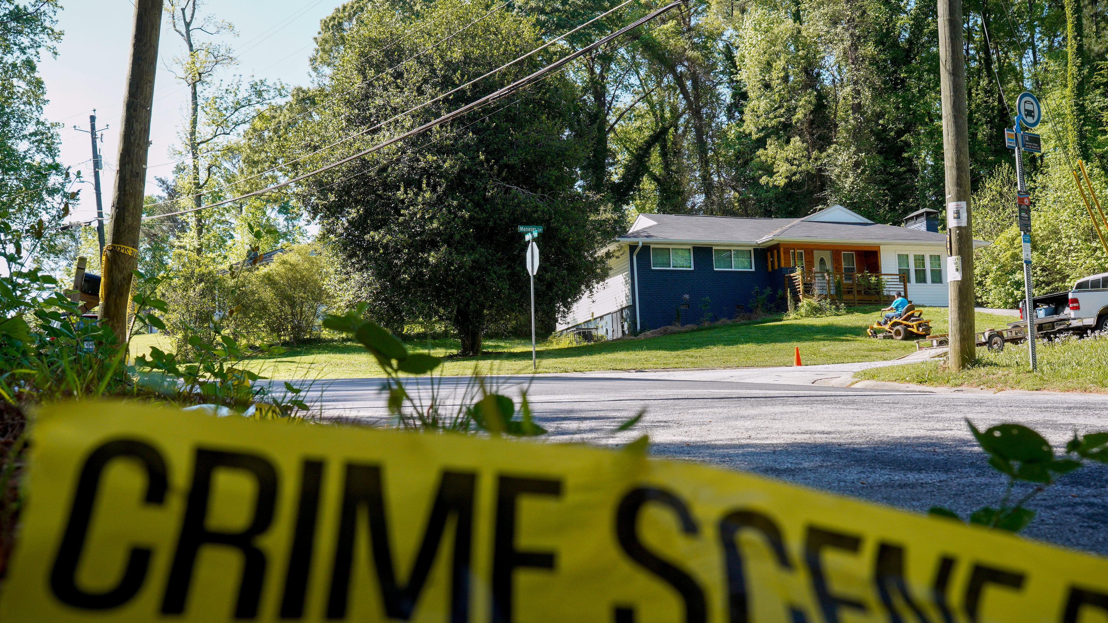 Only police tape remained on the street where Lauren Bullis, a U.S. Department of Homeland Security employee, was killed while walking her dog April 13, 2026. The accused suspect, Olaolukitan Adon Abel, now faces a federal firearms charge.(Ben Hendren for the AJC)