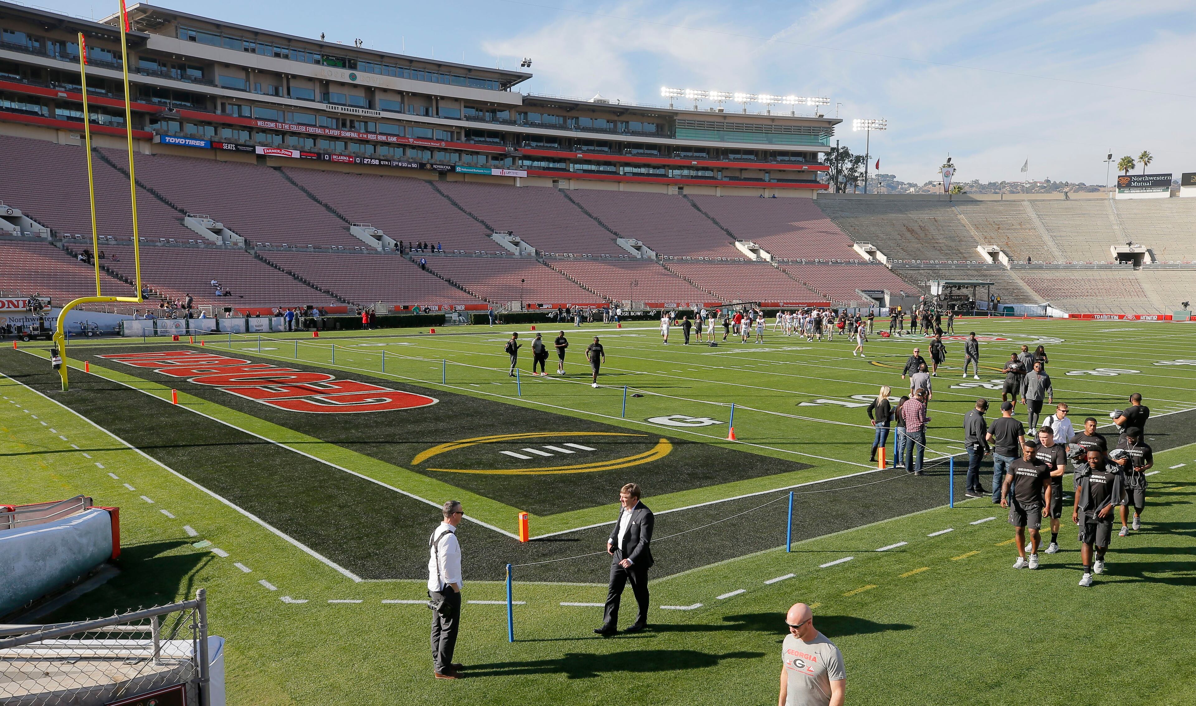 12/31/17 - Los Angeles - Georgia head coach Kirby Smart (center) walks off the field with his team they took an official team photo in front of the stadium, then took a walk around the field. Fans turned out at the Rose Bowl as both Georgia and Oklahoma arrived to take team photos. Georgia plays Oklahoma in a NCAA football playoff game on Monday at Spieker Field, and a victory there, will put the Bulldogs in Mercedes-Benz Stadium on Jan. 8 to play one of two rivals -- Alabama or Clemson -- for the national title. AJC Photo