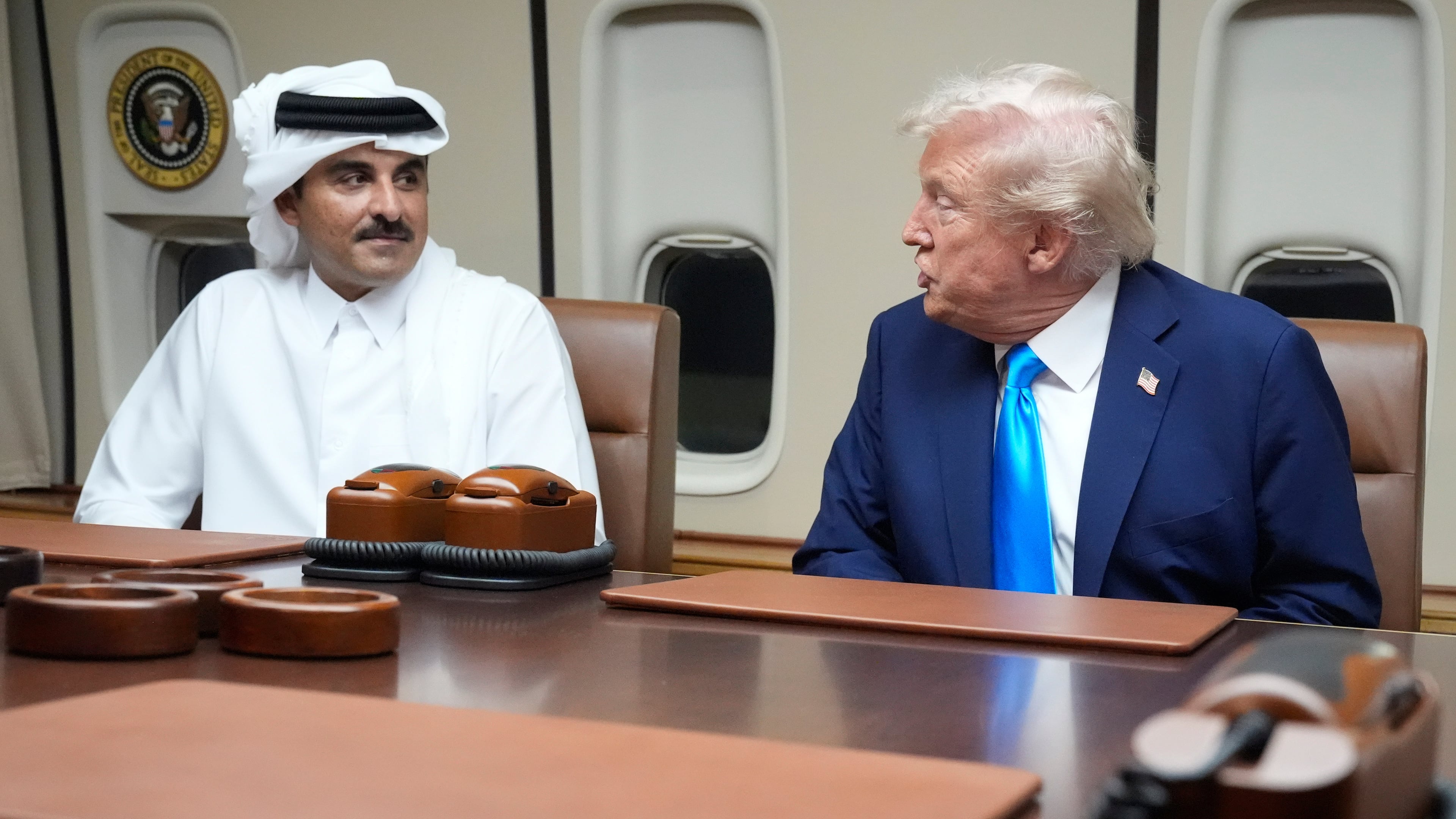 FILE - President Donald Trump, right, meets with Emir of Qatar Sheikh Tamim bin Hamad al-Thani aboard Air Force One at Al Udeid Air Base in Doha, Qatar, Saturday, Oct. 25, 2025. (AP Photo/Mark Schiefelbein, File)