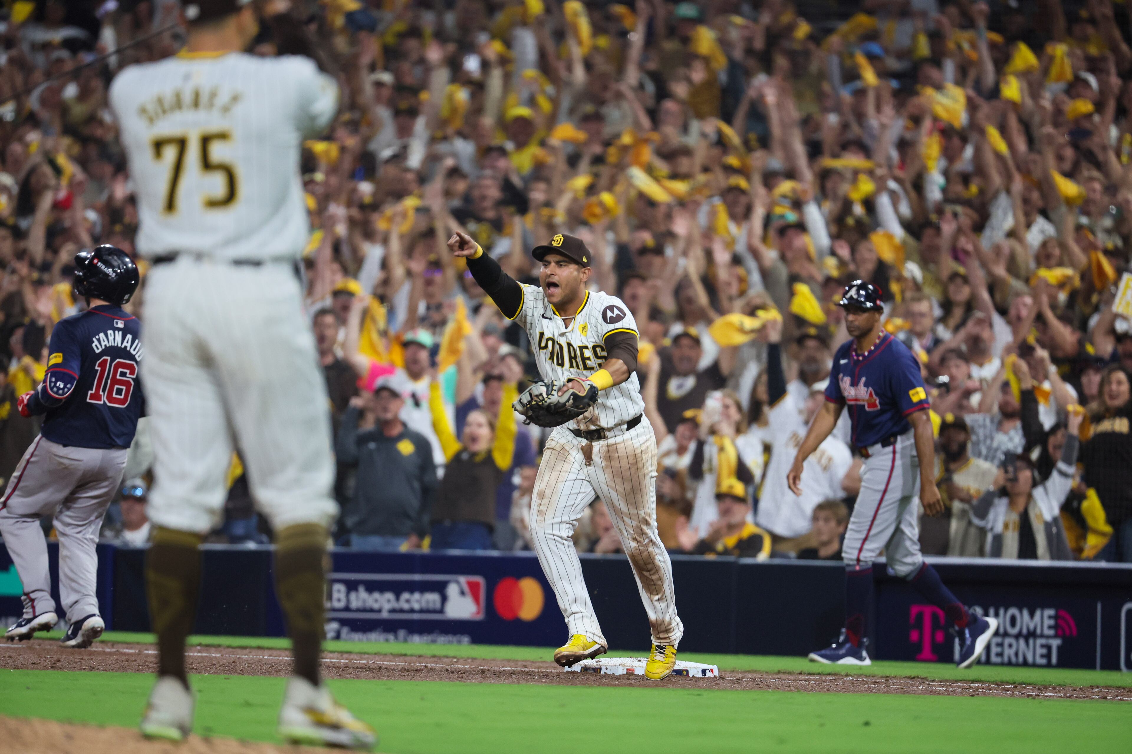Atlanta Braves catcher Travis d'Arnaud (16) is forced out by San Diego Padres first baseman Donovan Solano, left, to end the ninth inning of National League Division Series Wild Card Game One at Petco Park in San Diego on Tuesday, Oct. 1, 2024. San Diego won 4-0. (Jason Getz / Jason.Getz@ajc.com)