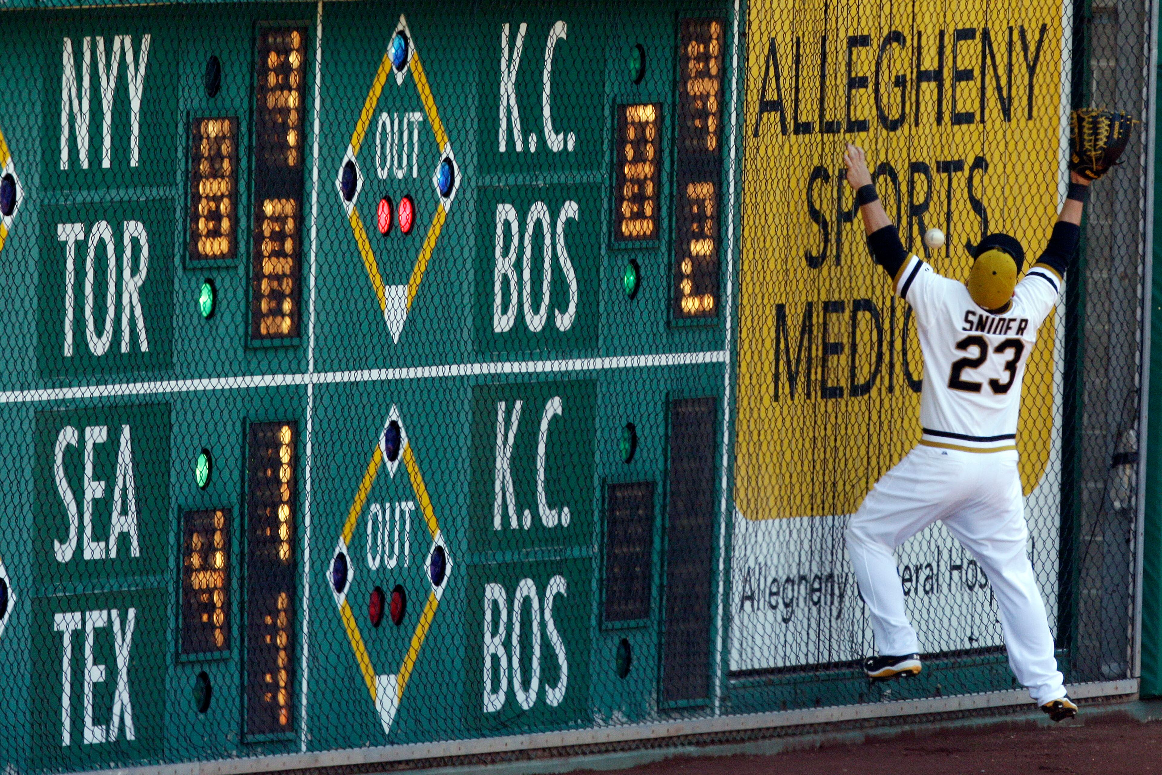 Pittsburgh Pirates right fielder Travis Snider (23) can't get to a ball hit off the right field wall by Atlanta Braves' Evan Gattis for a double during the seventh inning of a baseball game in Pittsburgh Sunday, April 21, 2013. (AP Photo/Gene J. Puskar)