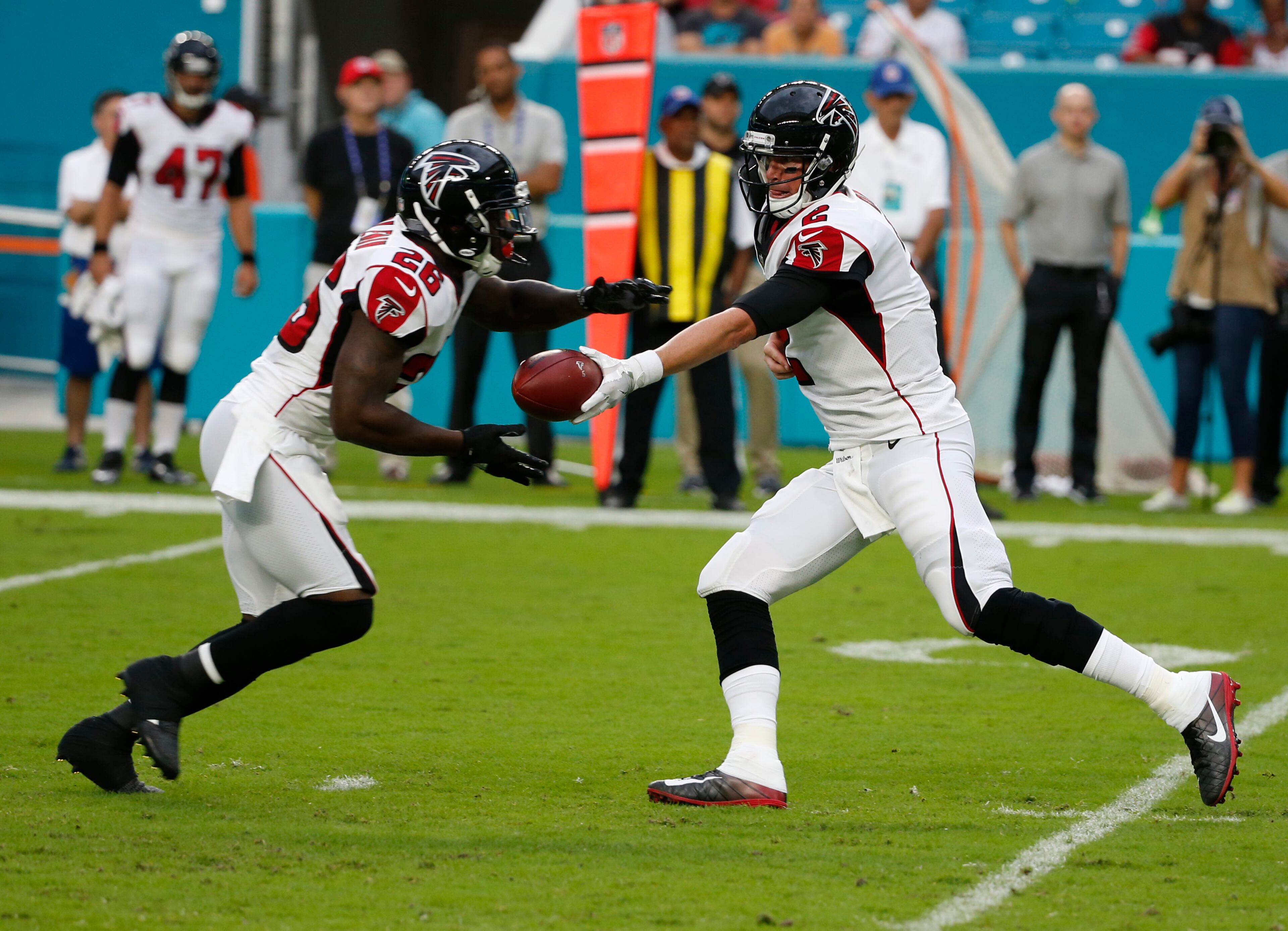 Atlanta Falcons quarterback Matt Ryan (2) hands the ball to running back Terron Ward (28) during the first half of an NFL preseason football game against the Miami Dolphins, Thursday, Aug. 10, 2017 in Miami Gardens, Fla. (AP Photo/Wilfredo Lee)
