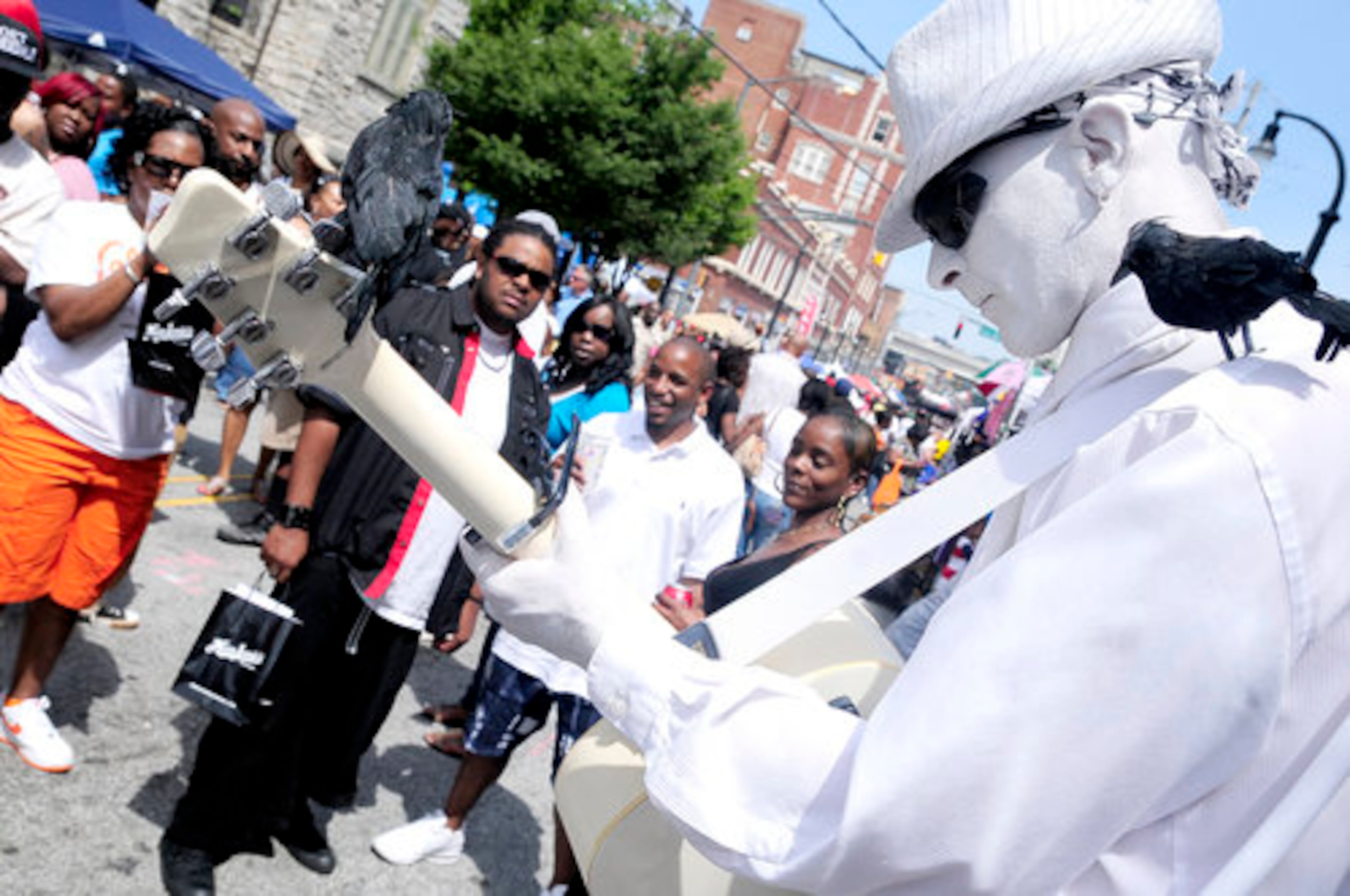 Ralph Longshore (whitemanentertainment.com) with his black birds, performs at the Sweet Auburn Ave. Festival.