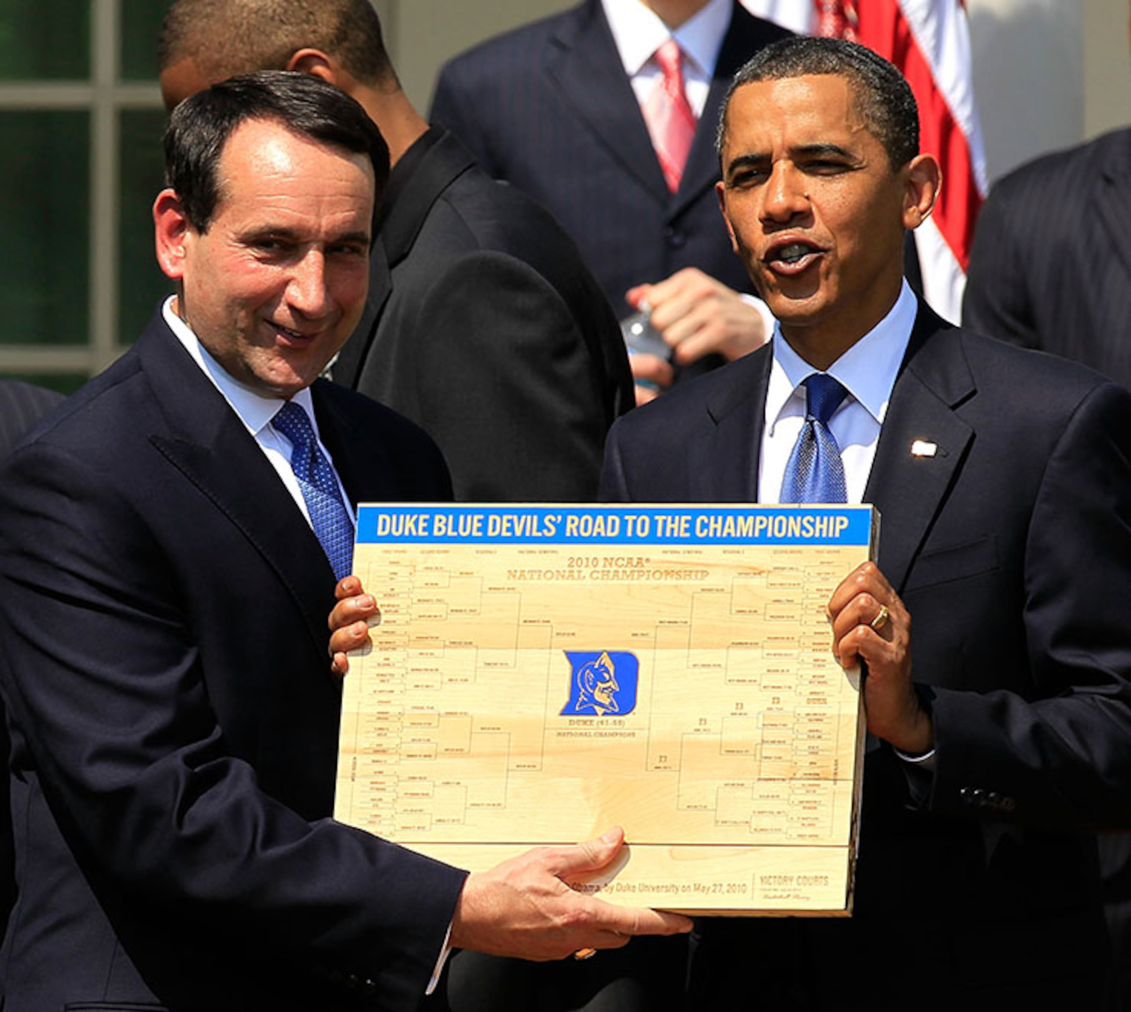 WASHINGTON - MAY 27: U.S. President Barack Obama (R) is presented with a plaque of a bracket by coach Mike Krzyzewski (L) of the Duke Blue Devils during a Rose Garden event May 27, 2010 at the White House in Washington, DC. Obama hosted the NCAA men basketball champions to honor their 2009-2010 season. (Photo by Alex Wong/Getty Images)