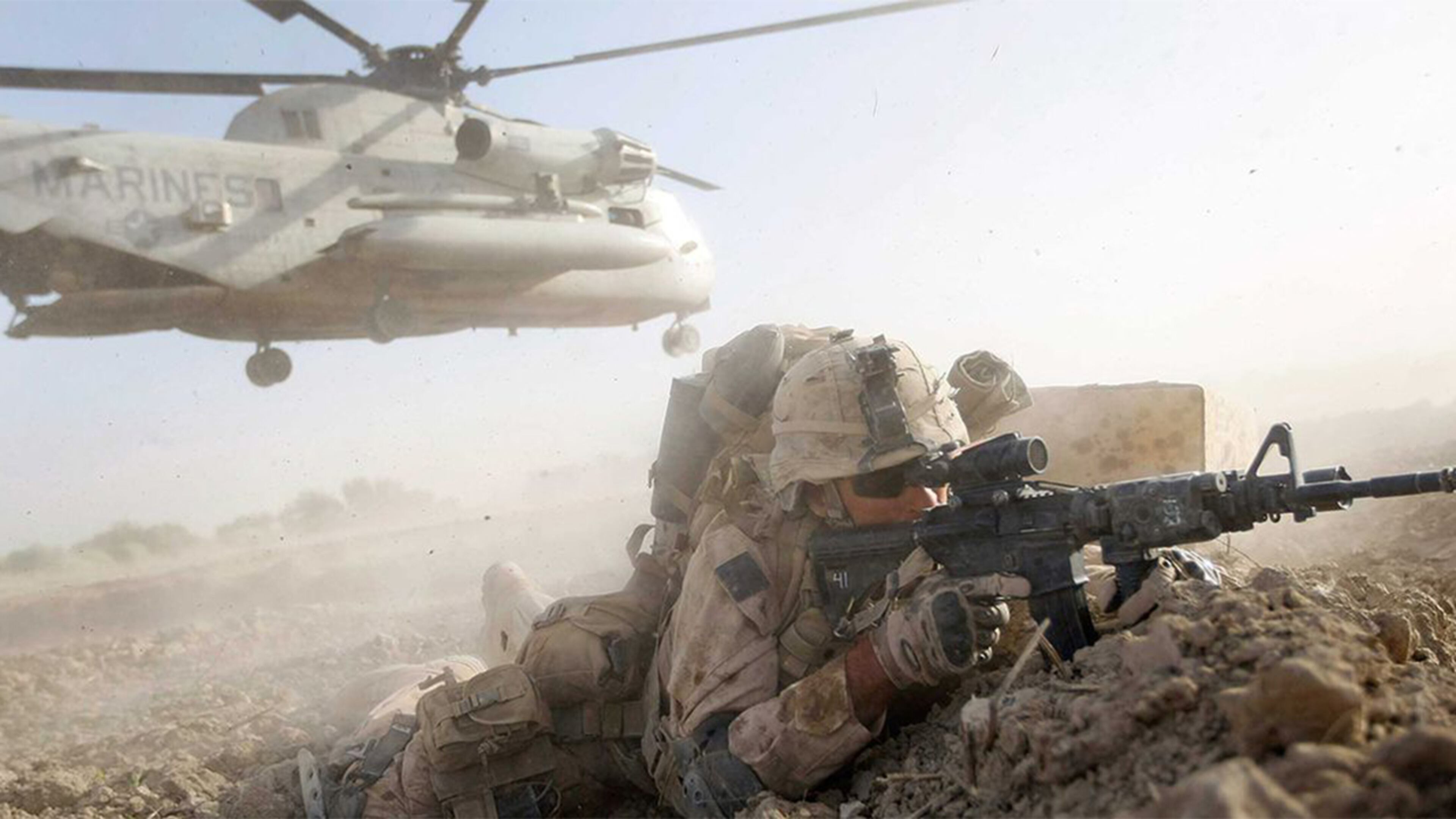 A U.S. Marine from 2nd Marine Expeditionary Brigade, RCT 2nd Battalion 8th Marines Echo Co. takes up a fighting position after off loading from a helicopter during the start of Operation Khanjari on July 2, 2009 in Main Poshteh, Afghanistan.