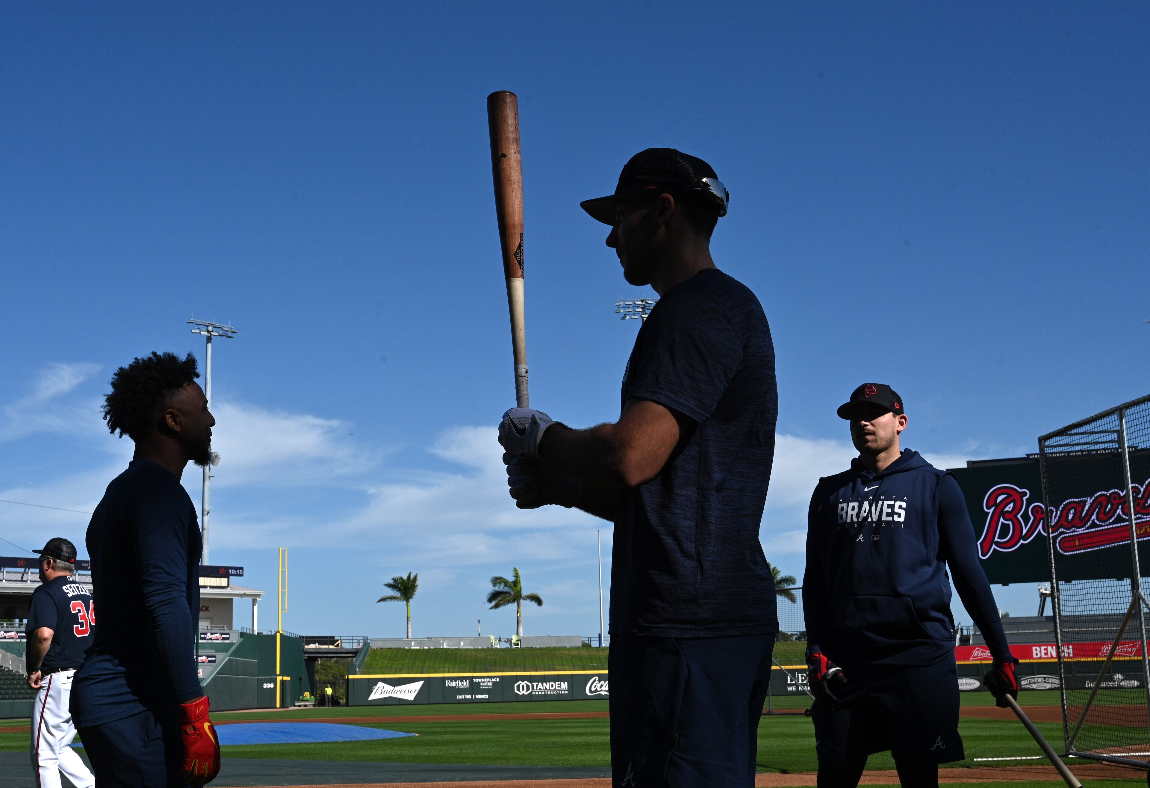 Braves second baseman Ozzie Albies (from left), first baseman Matt Olson and third baseman Austin Riley talk as they wait their turn for batting practice during spring training Thursday at CoolToday Park in North Port, Florida. (Hyosub Shin / Hyosub.Shin@ajc.com)