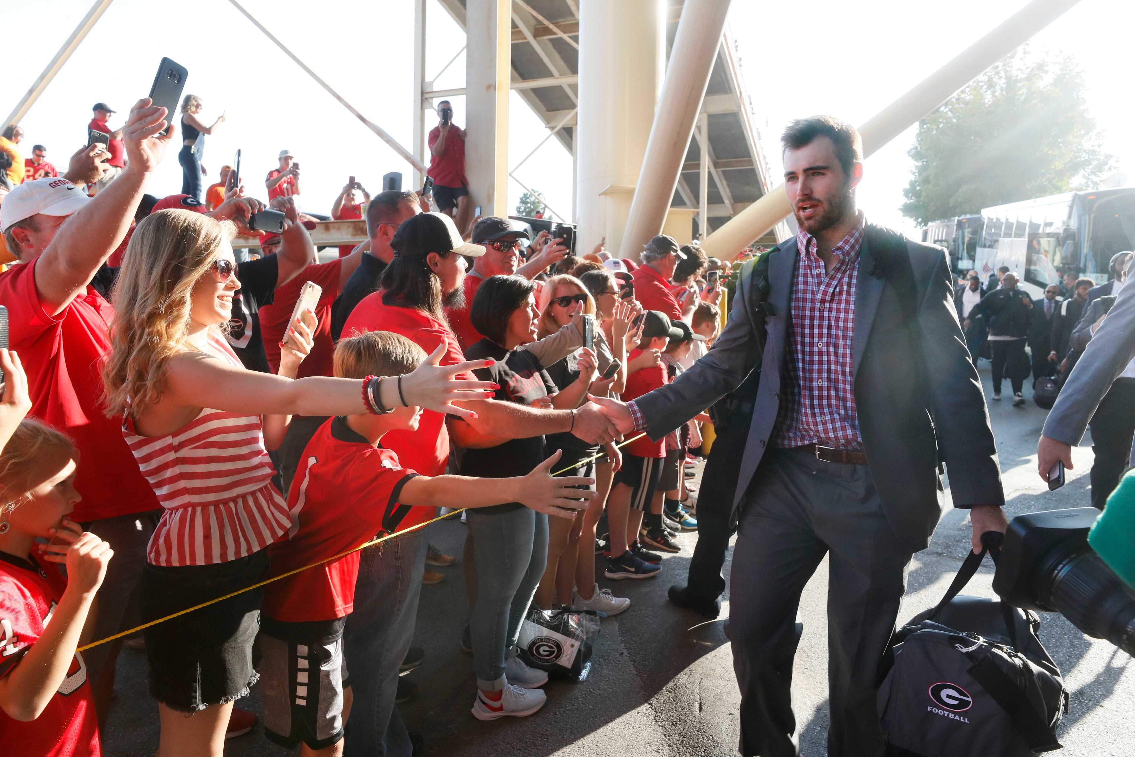Georgia Bulldogs quarterback Jake Fromm (11) greets fans as the team bus arrives at Neyland Stadium. Bob Andres / robert.andres@ajc.com