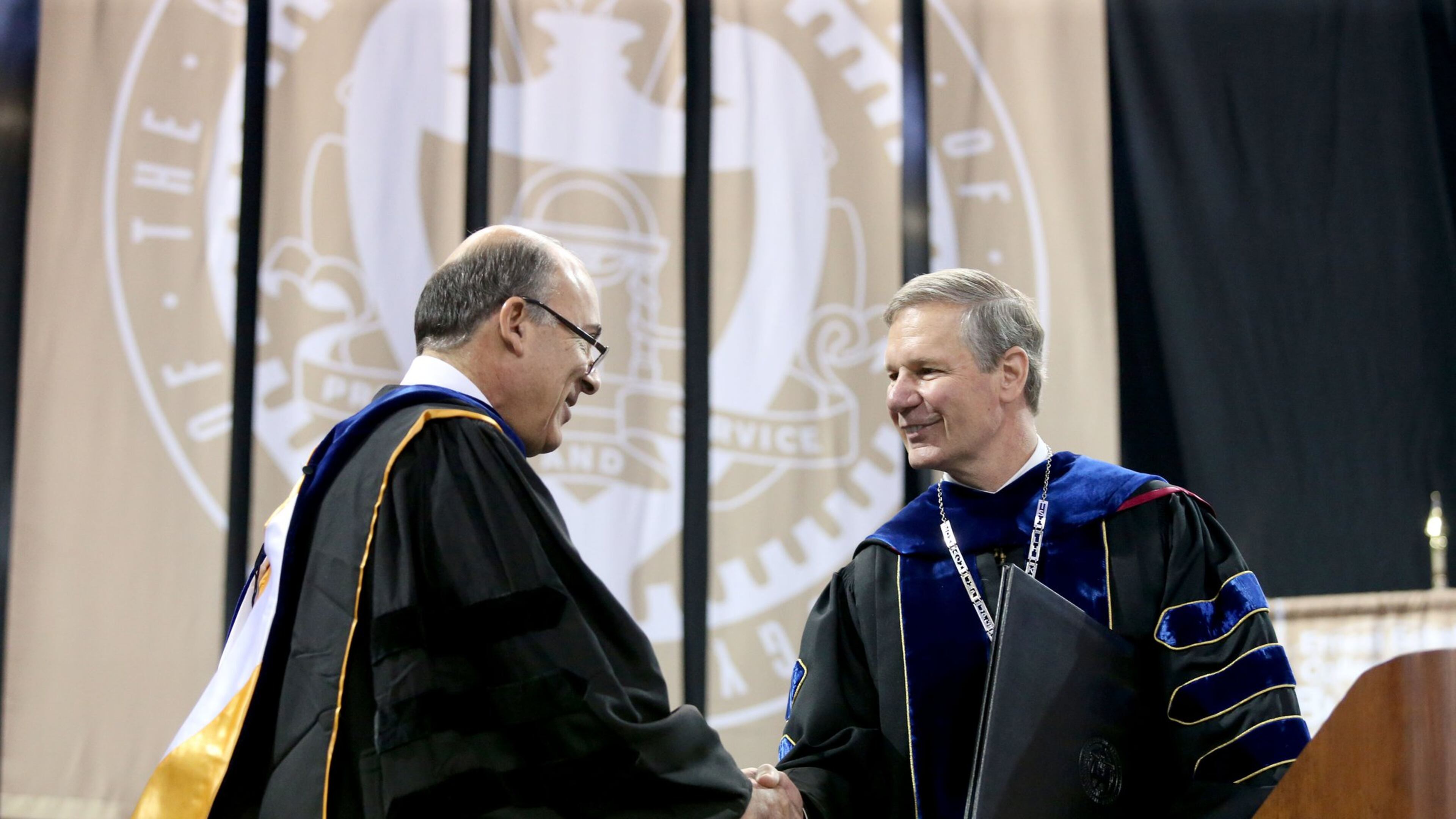 Muhtar Kent, Chairman of the Board of The Coca-Cola Company, (left) greets Georgia Tech President Bud Peterson before Kent’s speech during the Georgia Tech Bachelor’s morning ceremony of Spring 2014 Commencement at the McCamish Pavilion Saturday morning May 3, 2014 in Atlanta, Ga. (Photo/Jason Getz)