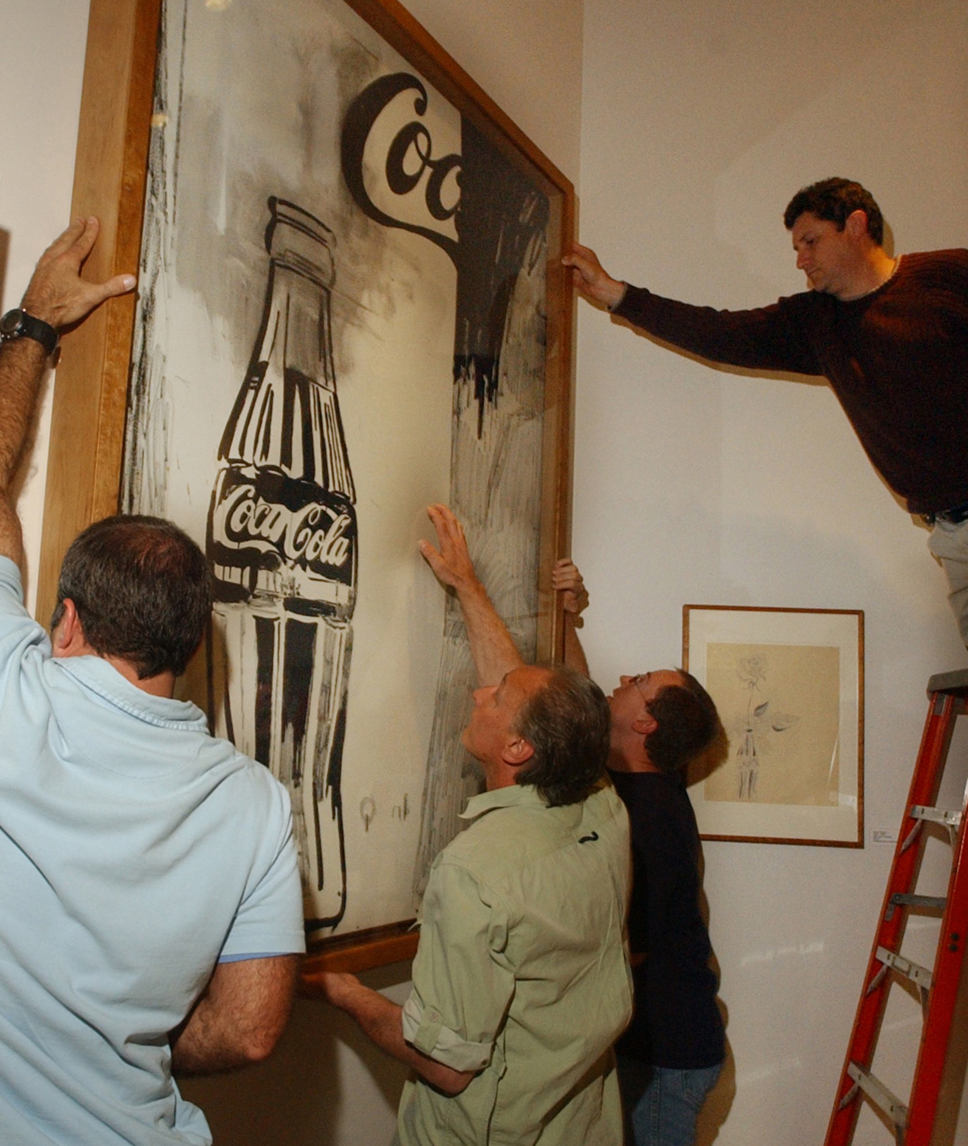 Mike Gokey, Gary Super, Glen Kyle and John Otte (on ladder) of GLS museum designers install an Andy Warhol piece titled "Coca-Cola 2" at new World of Coca-Cola Wed. 5/2/07 in Atlanta (Kimberly Smith / AJC staff)