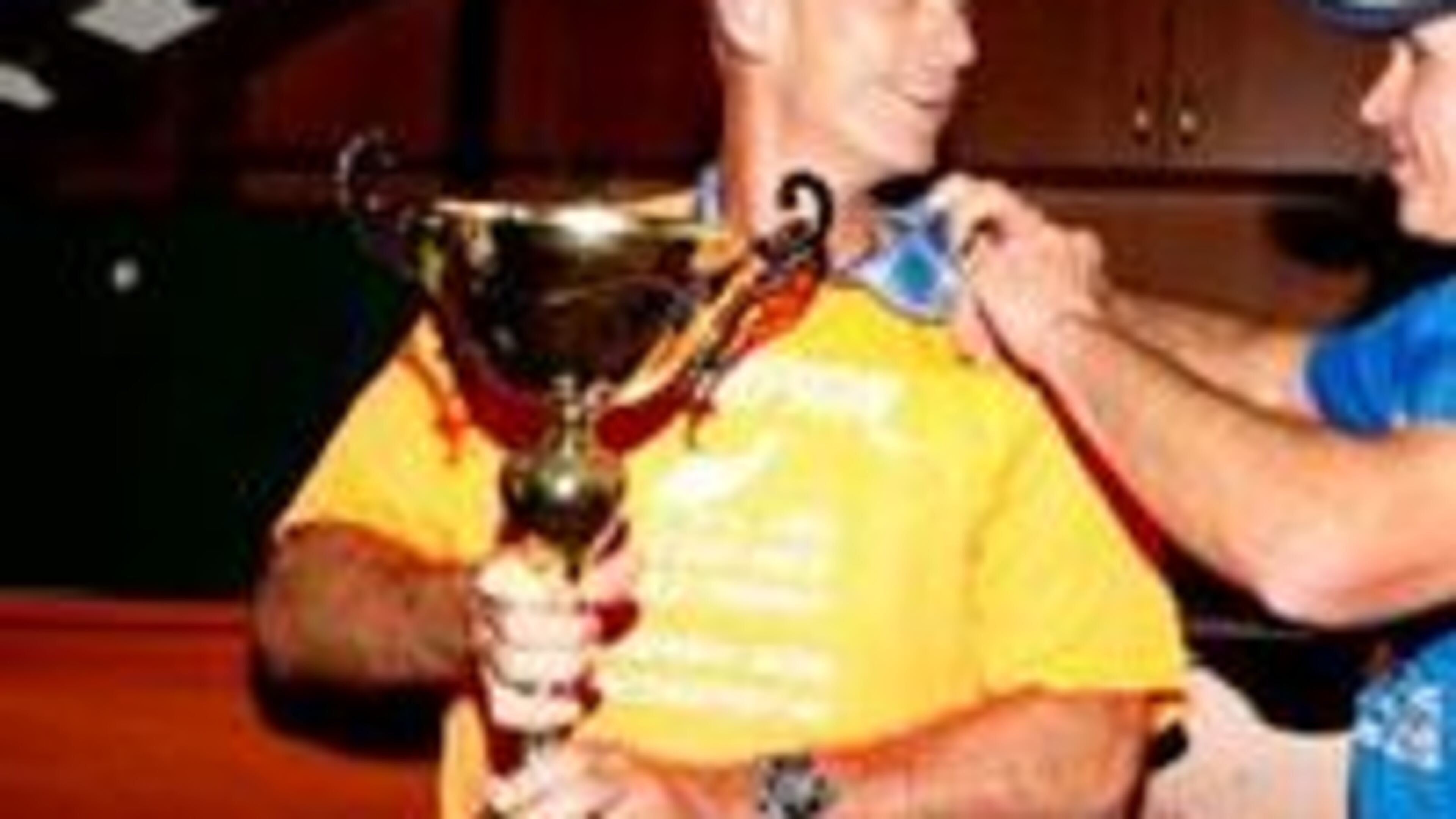 Joe Fejes holds championship trophy (emu 6 Day Ultramarathon)