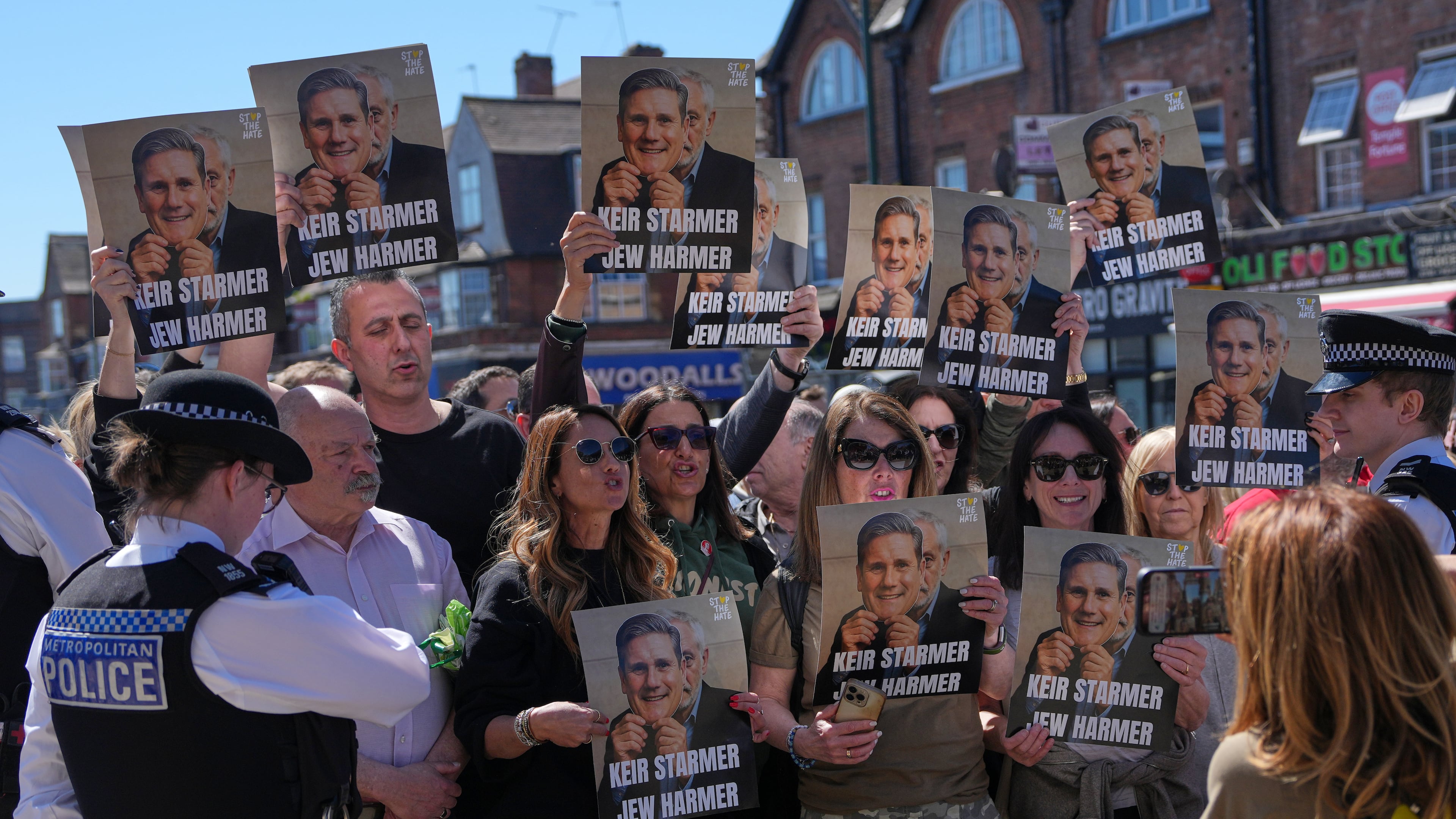 Protesters hold posters near the scene where two people were stabbed yesterday in the Golders Green neighbourhood, that has a large Jewish community, in London, Thursday, April 30, 2026.(AP Photo/Alastair Grant)