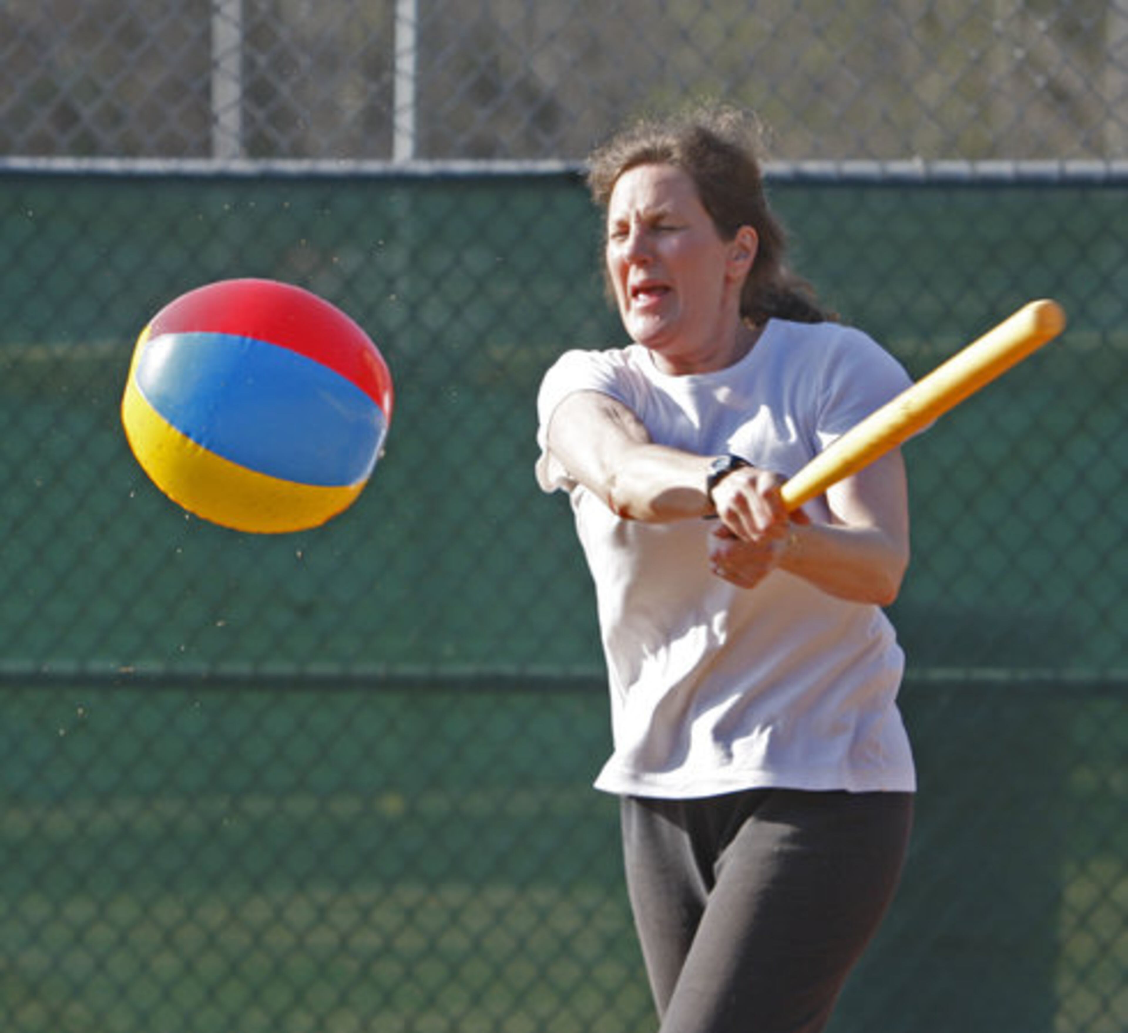Bonnie Haschke takes a swing during beach ball baseball. She had to run the bases after hitting the ball.