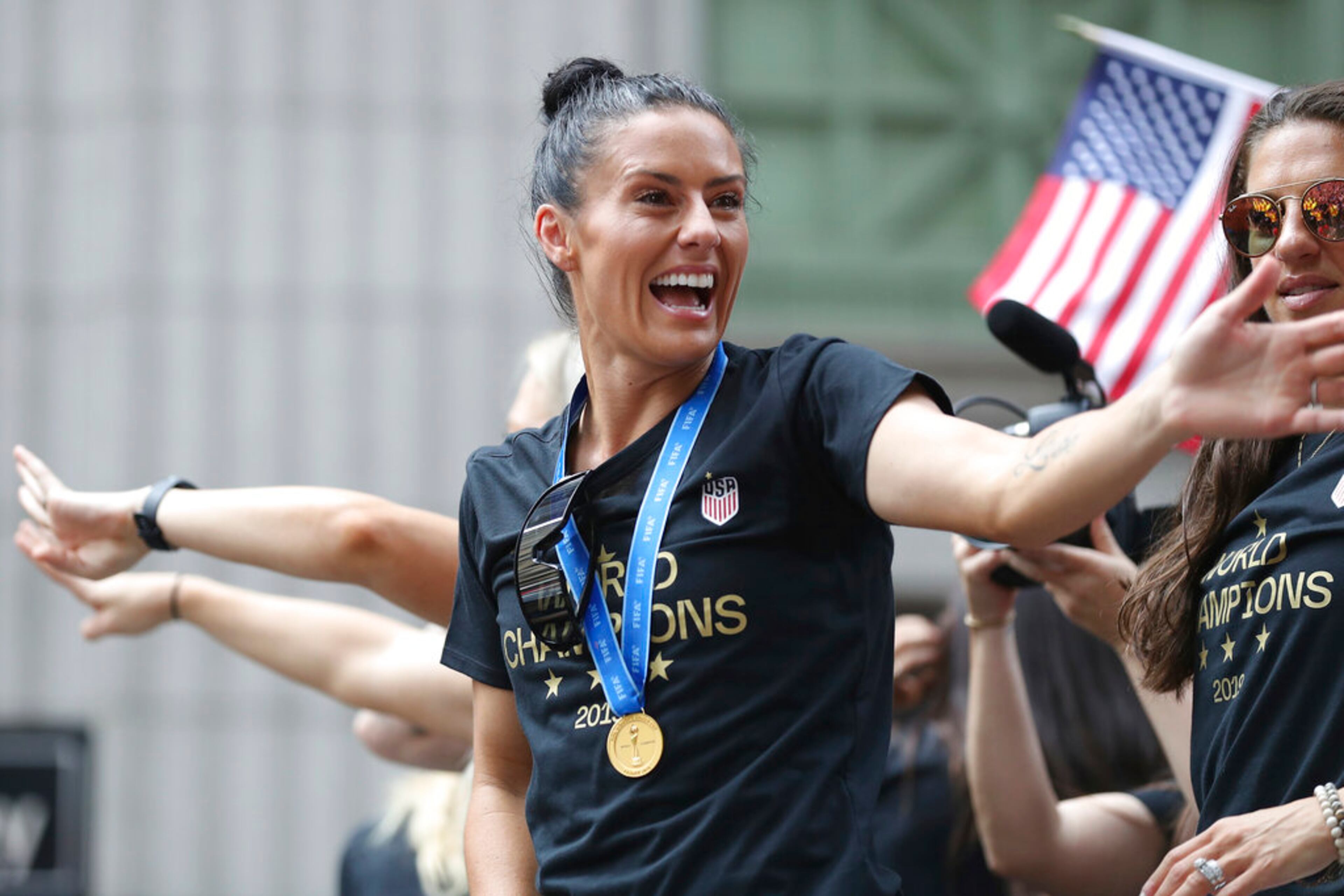 United States defender Ali Krieger waves to fans on a float while being honored with a ticker tape parade along the Canyon of Heroes, Wednesday, July 10, 2019, in New York. The U.S. national team beat the Netherlands 2-0 to capture a record fourth Women's World Cup title. (AP Photo/Steve Luciano)