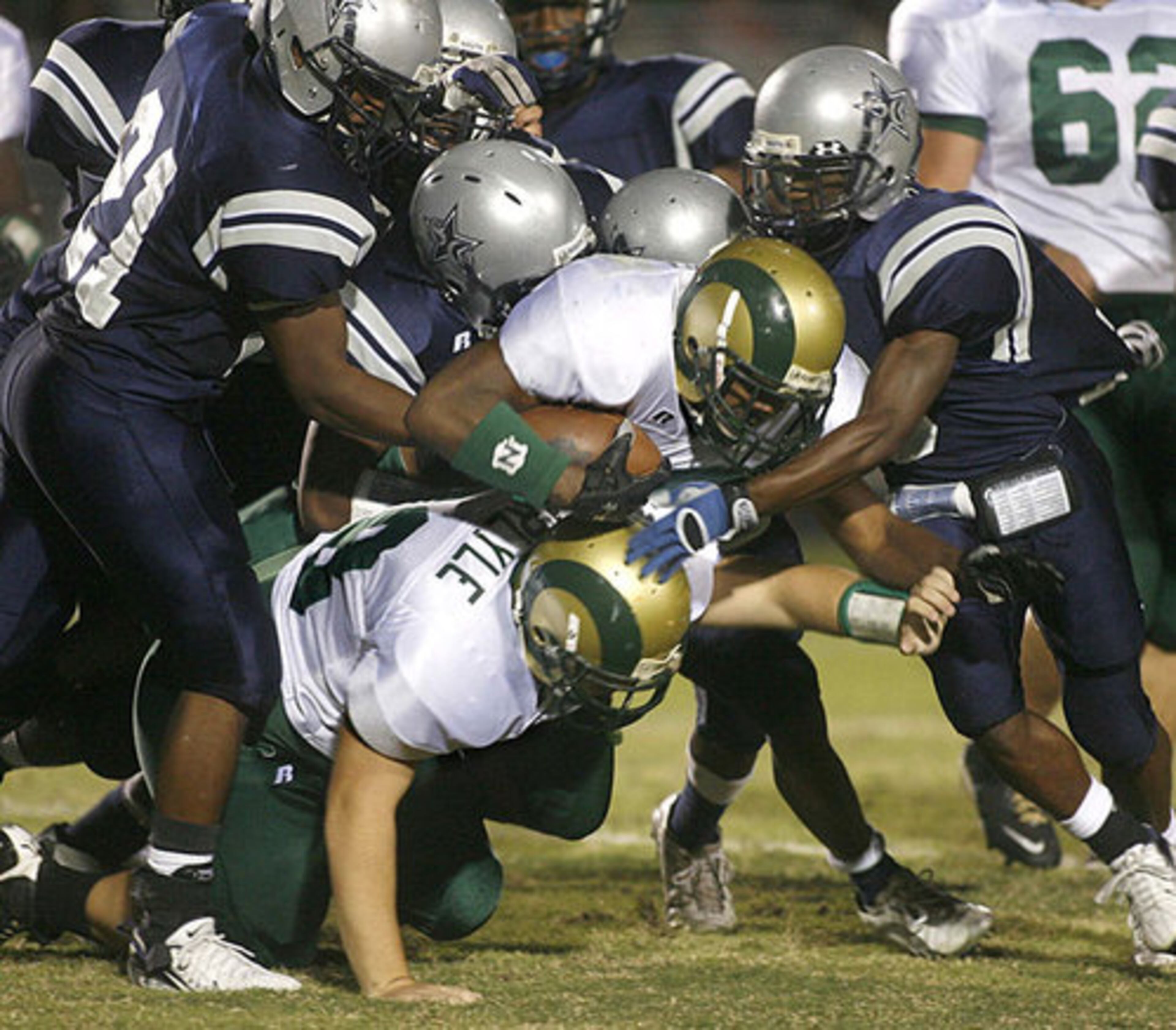 Grayson's Harrell Gunn (28) fights for more yardage against the Comets' defense.