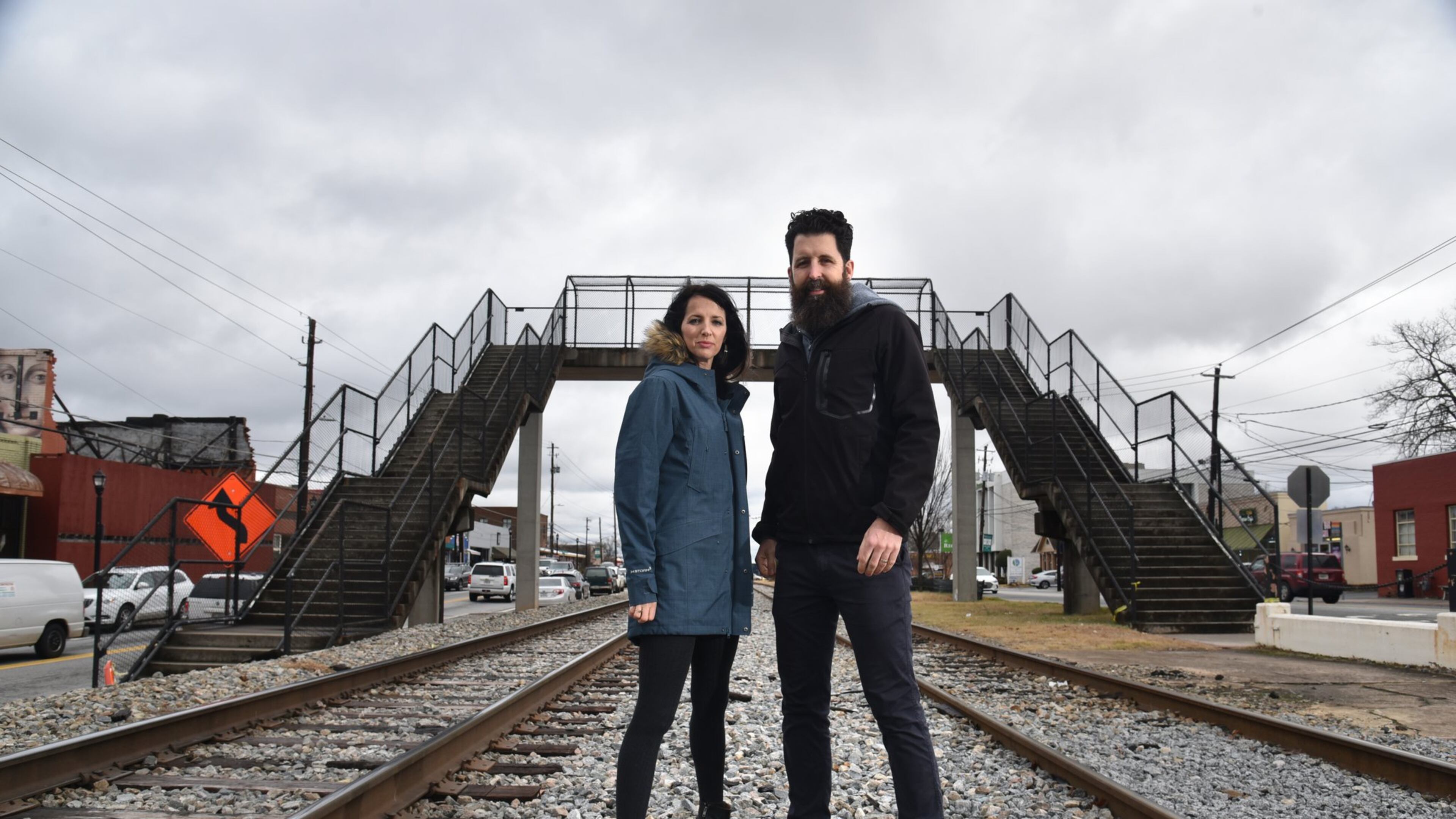 College Park residents Whitney (left) and Micah Stansell have been commissioned to tranform the Hapeville Pedestrian Bridge, visible in the background, into a public art installation. HYOSUB SHIN / HSHIN@AJC.COM