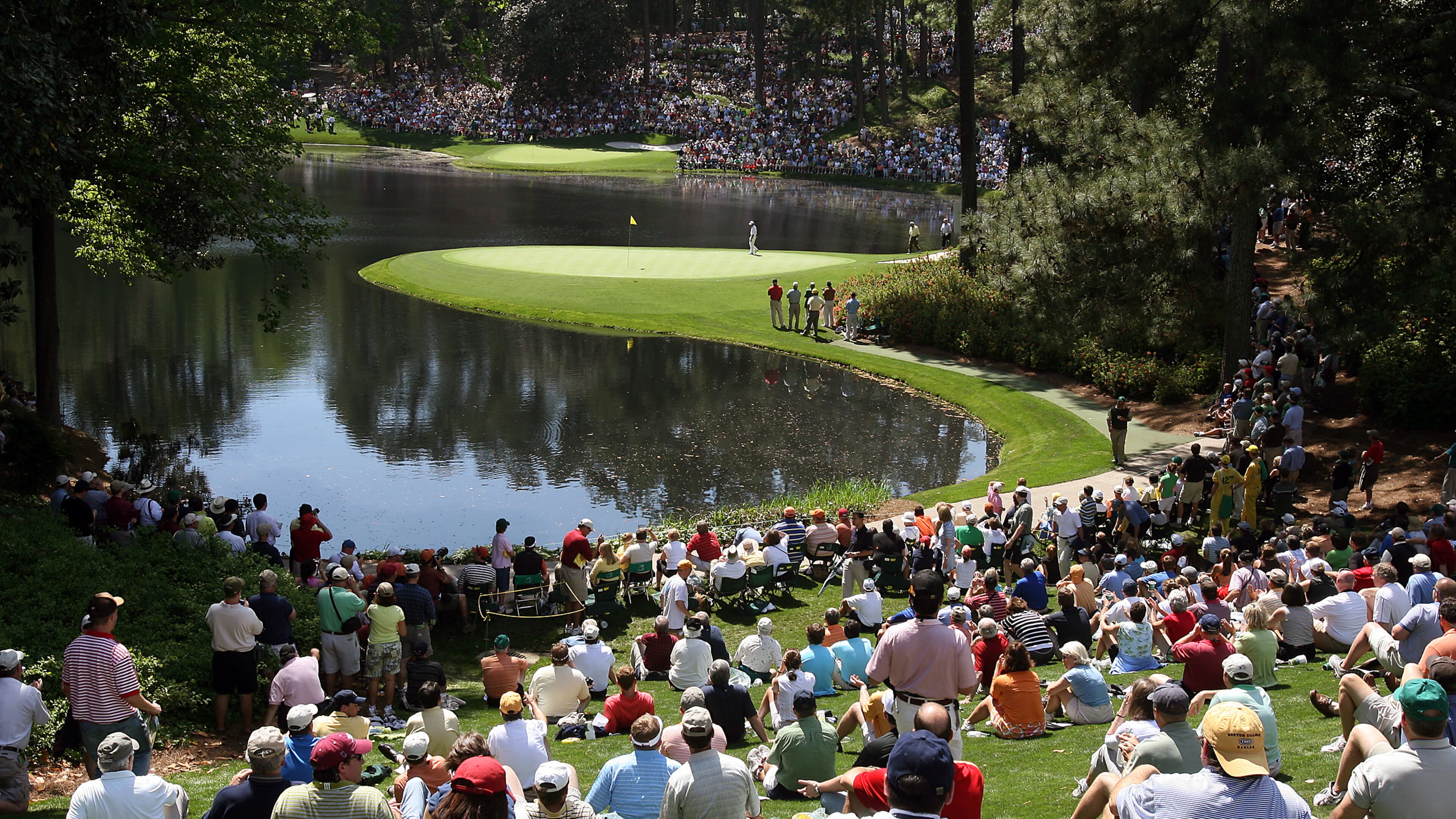 Patrons watch Gary Player on the 8th green during the Par 3 contest Wednesday, April 4, 2007, at Augusta National Golf Club in Augusta.