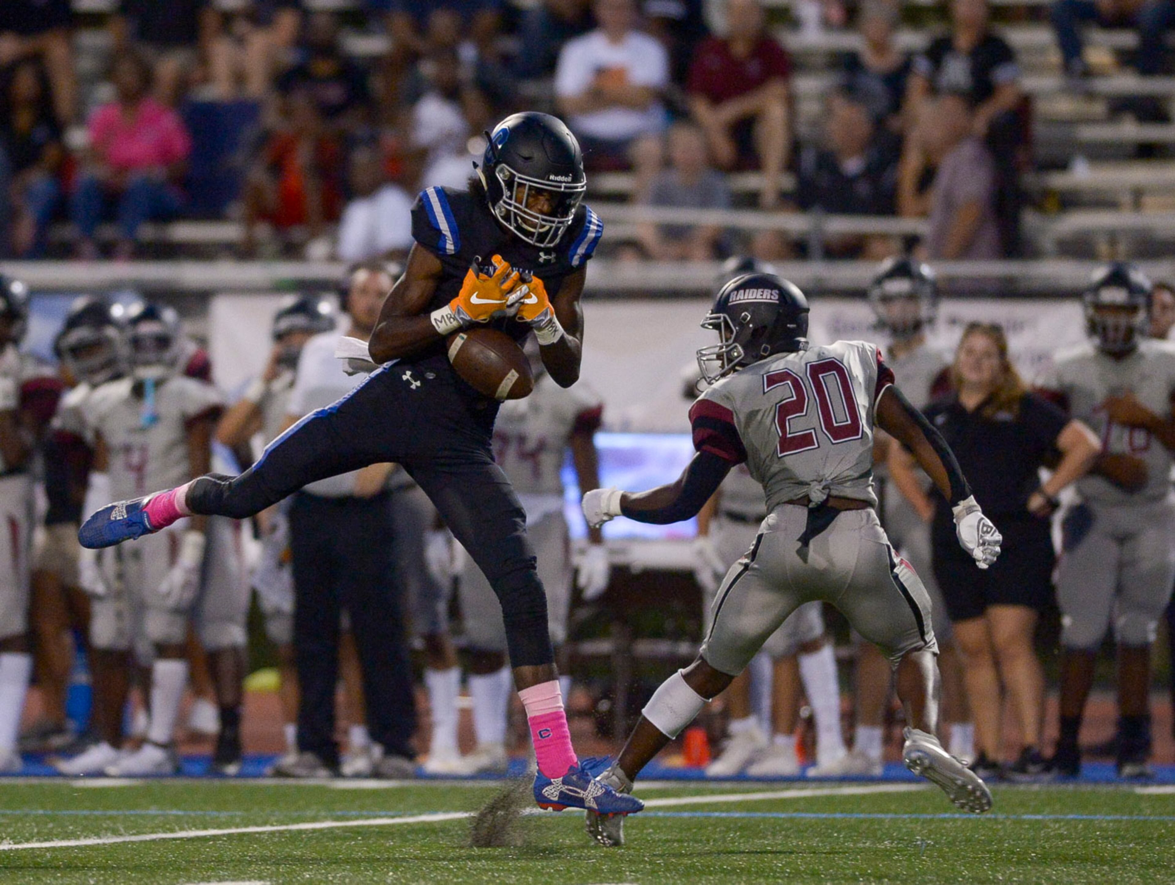 Centennial wide receiver Drake Mason (1) lets a reception slip away under pressure from Alpharetta defemder Kris Thomas (20) in the first half of Friday's game at Centennial. (Daniel Varnado/Special)