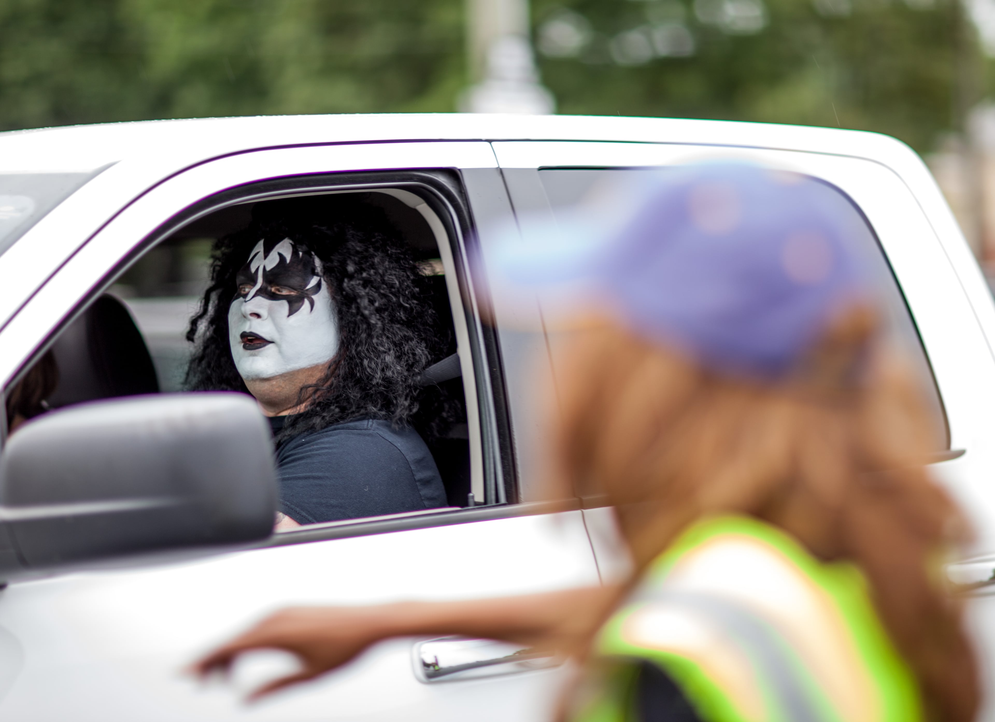 A guard, right, directs Sheldon McKinney where to park at Aaron's Amphitheatre at Lakewood Friday, July 18, 2014 in Atlanta, Ga. KISS and Def Leppard made a stop in Atlanta during their 42-city North American tour.