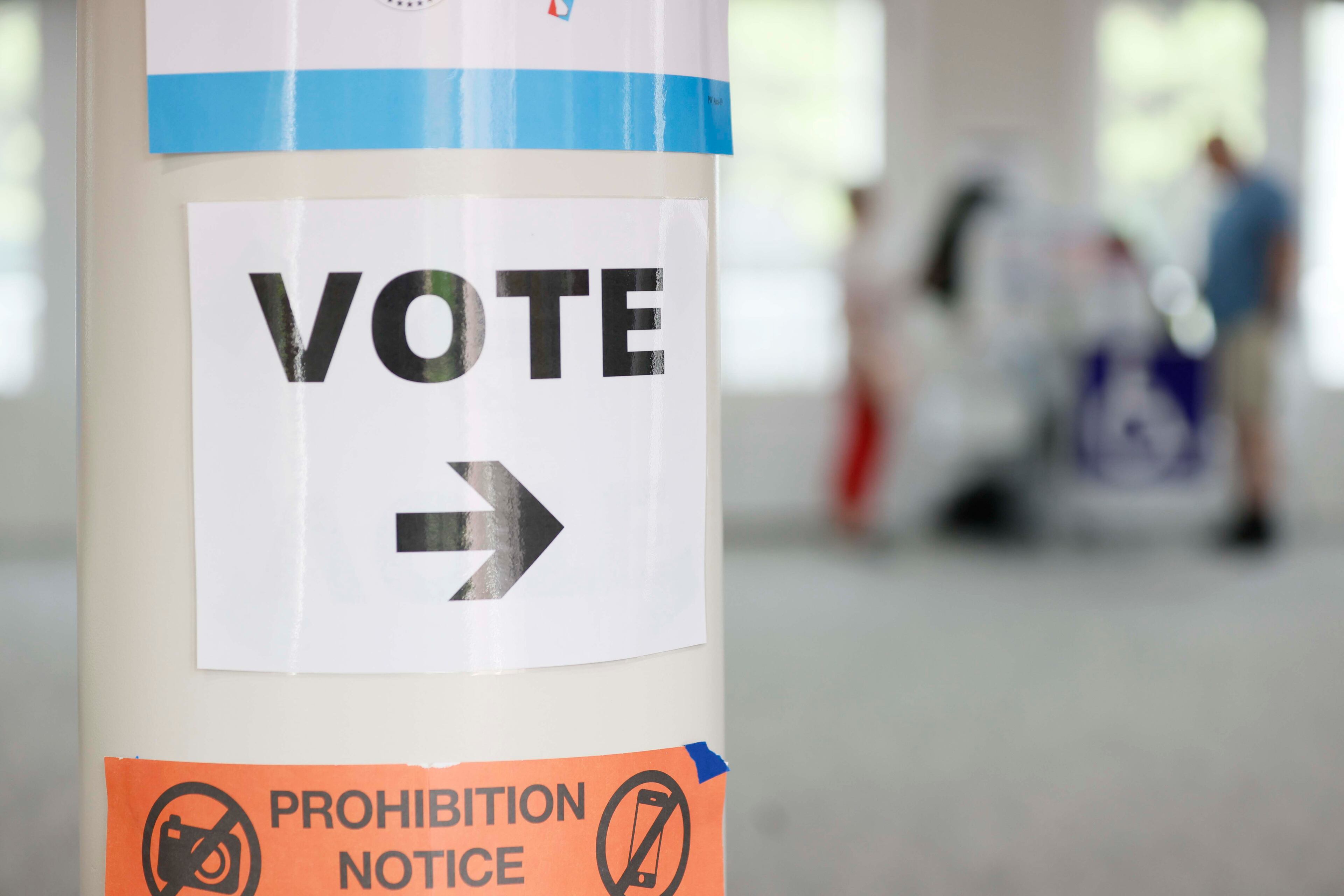 A sign helps voters find the voting machines at the River-Green subdivision in Canton. Voters were deciding on seven candidates in the special election for the District 21 state Senate seat vacated by Brandon Beach. The winner will serve until January 2027. (Miguel Martinez/AJC)
