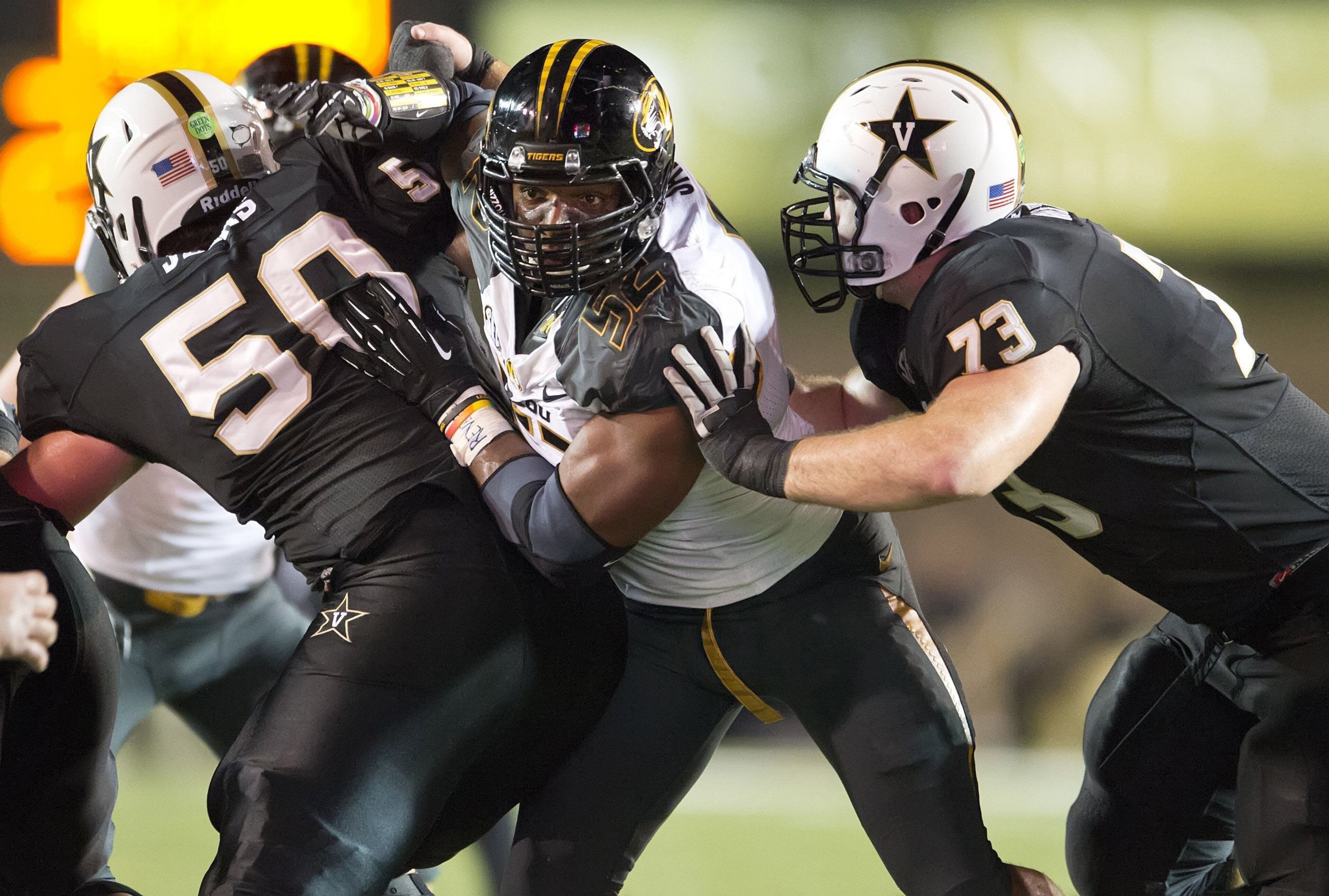 Missouri defensive lineman Michael Sam, center, works through Vanderbilt linemen on October 5, 2013.